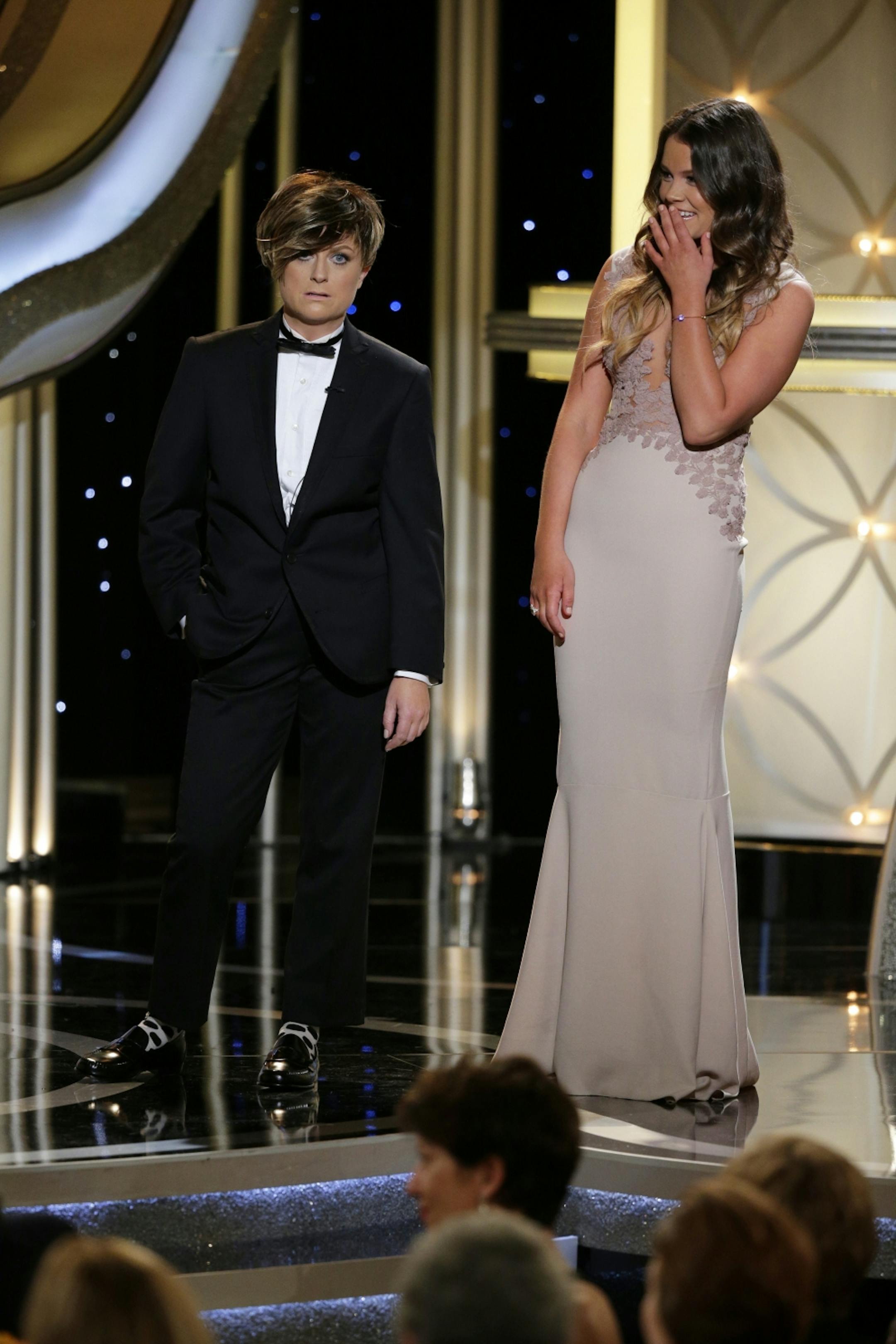 This image released by NBC shows host Amy Poehler, left, and Miss Golden Globe Sosie Bacon during the 71st annual Golden Globe Awards at the Beverly Hilton Hotel on Sunday, Jan. 12, 2014, in Beverly Hills, Calif.