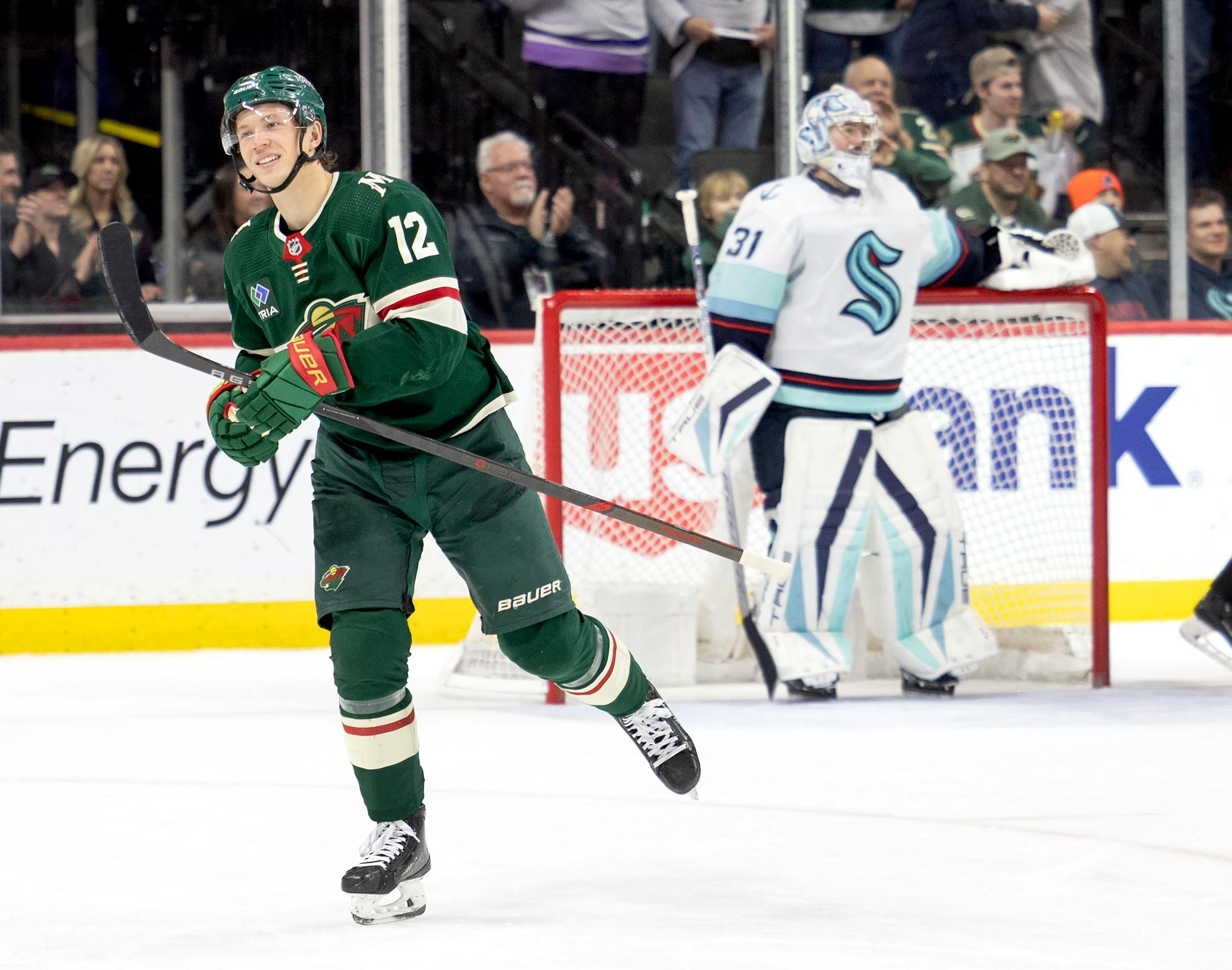 Matt Boldy (12) of the Minnesota Wild celebrates with teammates after scoring his second goal in the second period.