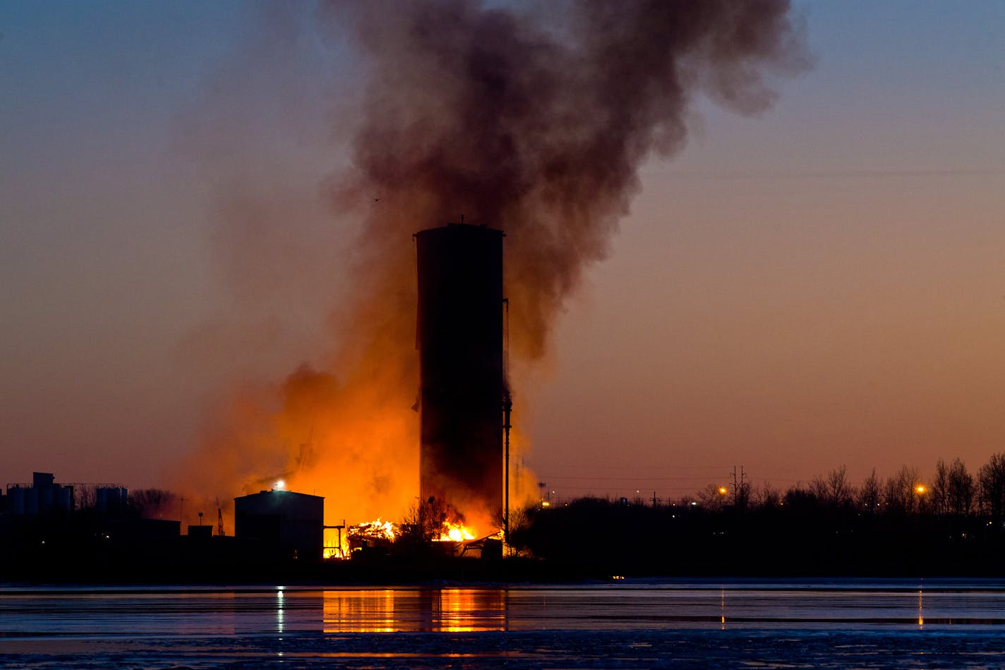 Firefighters worked to extinguish a fire at the Globe Elevator in Superior, Wis., Monday. The wooden elevator was built in 1887 and decommisioned in 1989.