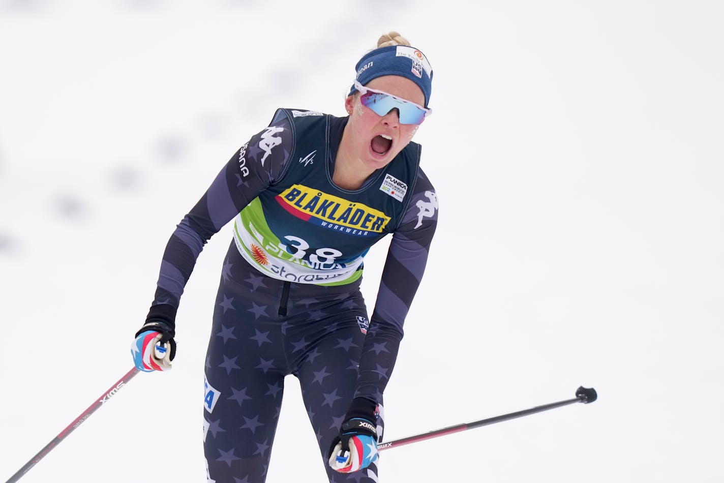 Jessie Diggins, of the United States, crosses the finish line to win the Women's Cross Country Interval Start 10 KM Free event at the Nordic World Championships in Planica, Slovenia, Tuesday, Feb. 28, 2023. (AP Photo/Matthias Schrader)