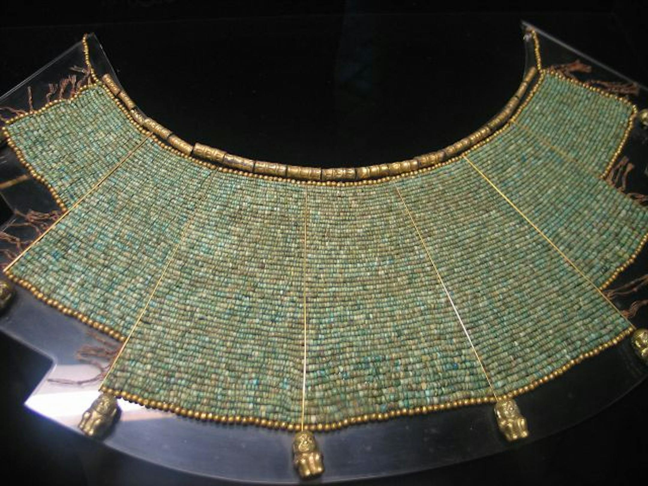 Gold and turquoise necklace sits on display at the Museo Larco in Lima, Peru.