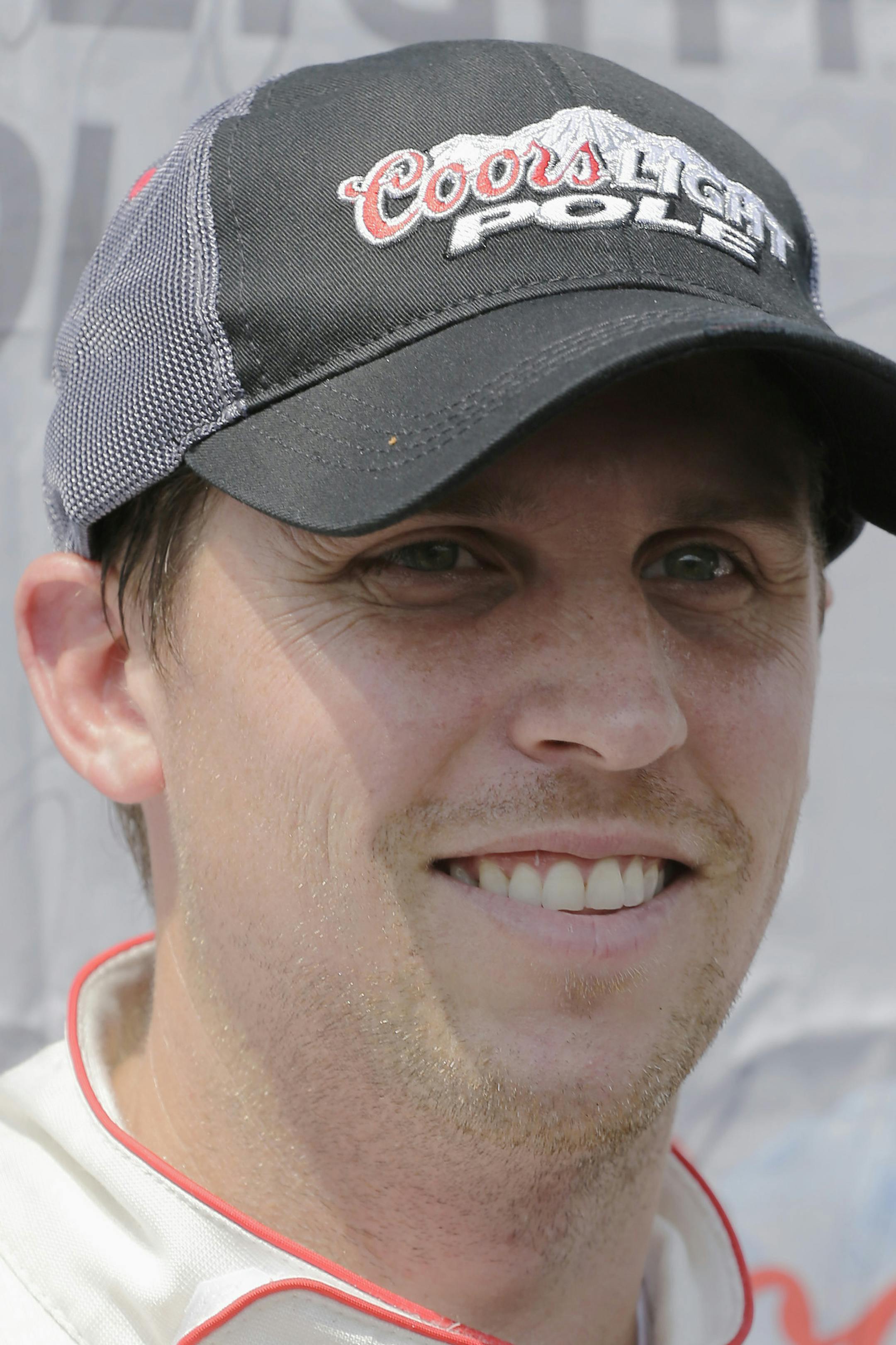 Denny Hamlin poses for the media after winning the pole position during qualifying for the NASCAR Xfinity auto race at Darlington Raceway in Darlington, S.C., Saturday, Sept. 5, 2015. (AP Photo/Terry Renna)