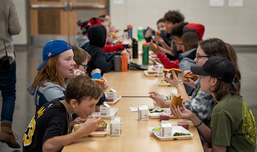 Fifth graders ate school lunch at Champlin-Brooklyn Park Academy on Friday, Feb. 17, 2023 in Champlin, Minn.