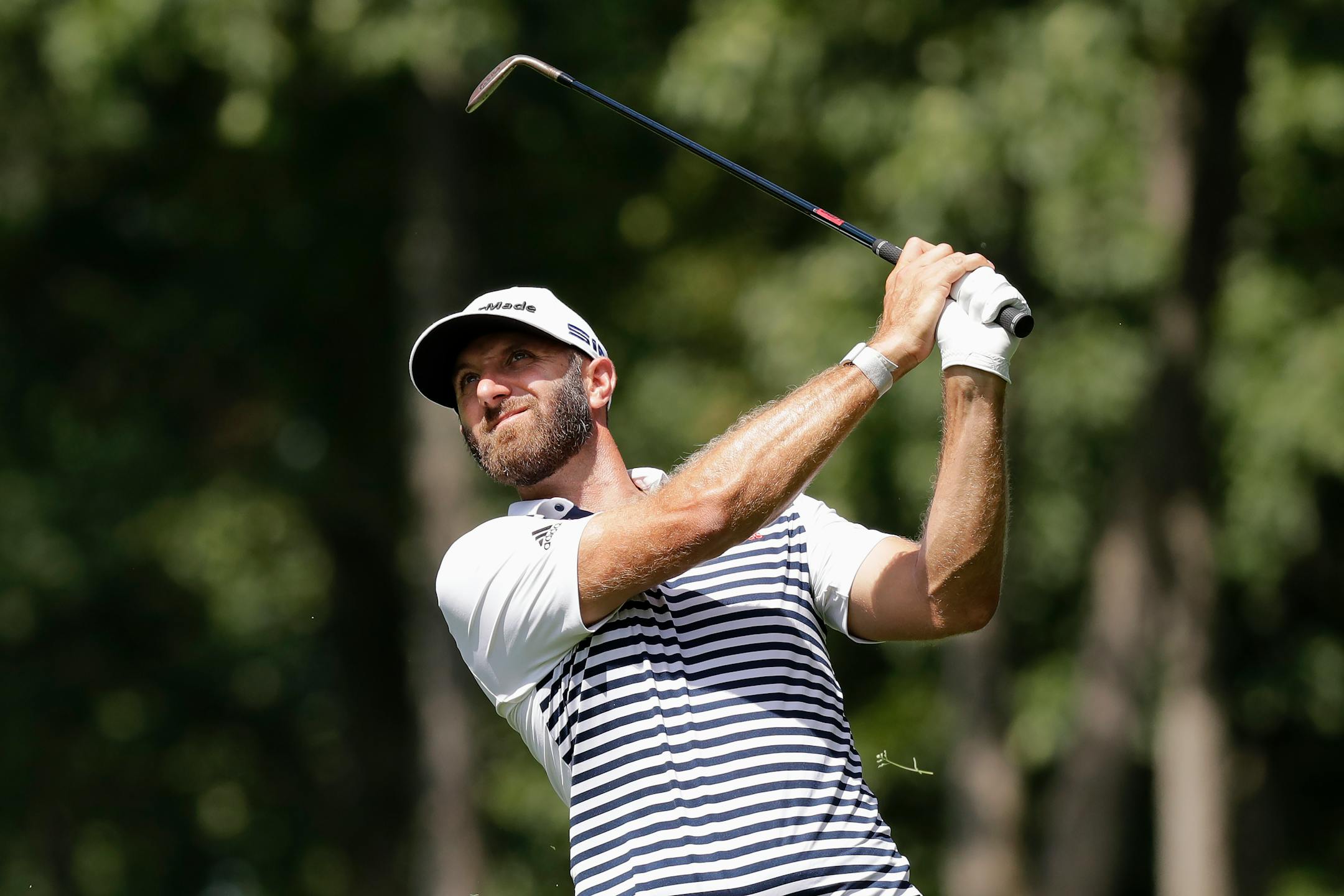 Dustin Johnson hits toward the ninth green during the second round of the Memorial golf tournament