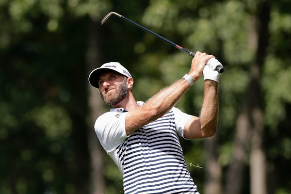 Dustin Johnson hits toward the ninth green during the second round of the Memorial golf tournament