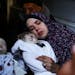 Rania Abu Anza cradles her twins, who were killed in an Israel strike on a house in Rafah, in the southern Gaza Strip, Sunday, March 3, 2024. Abu Anza