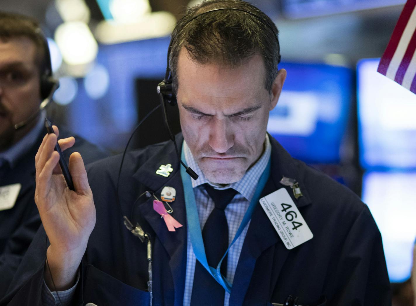 Stock trader Gregory Rowe works at the New York Stock Exchange, Tuesday, Feb. 4, 2020.