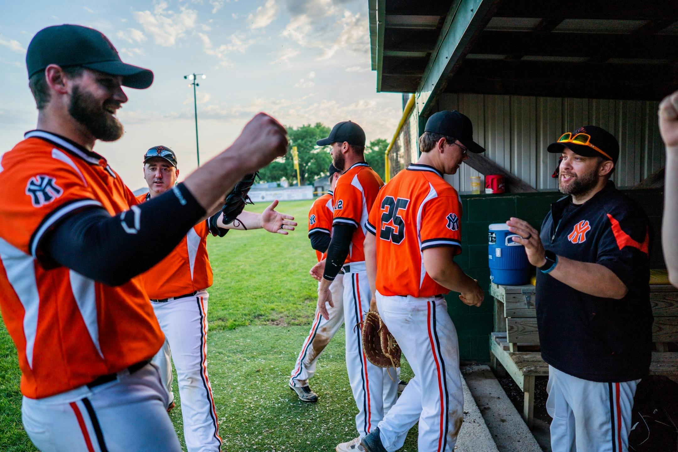 Milroy Yankees coach Ryan Rohlik celebrated with his team after closing out an inning against Spicer at Yankee Field.