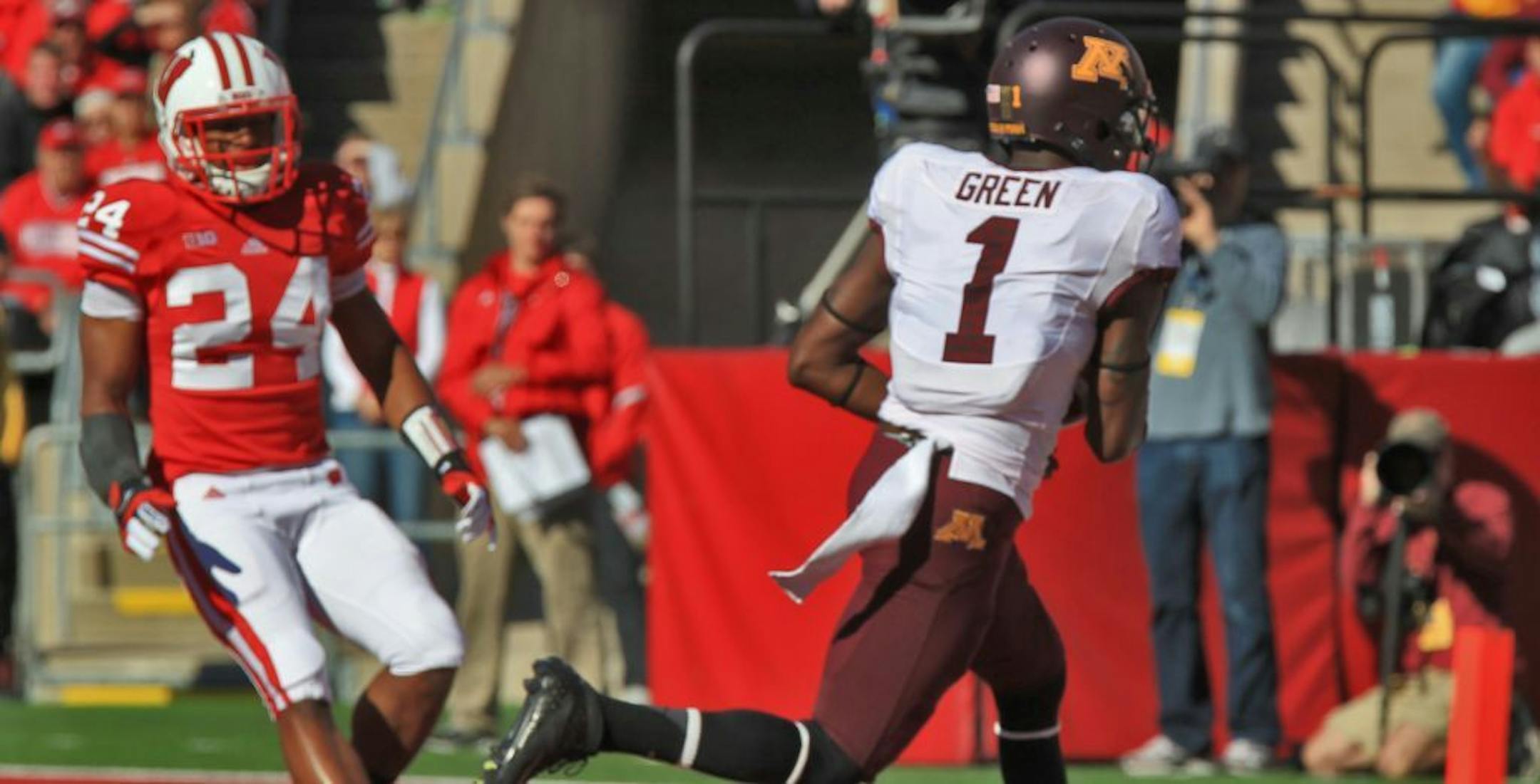Minnesota's Brandon Green ran past Wisconsin defender Shelton Johnson in the process of scoring a first quarter touchdown.