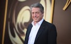 FILE - Hugh Grant arrives at the premiere of "Wonka" on Dec. 10, 2023, at Regency Village Theatre in Westwood, Calif. Hugh Grant says he received “a