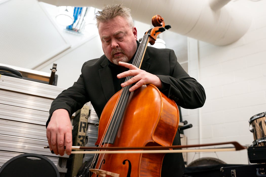 Gene Schott of Austin High School warms up backstage during intermission before performing “Jupiter” in Saturday's concert.