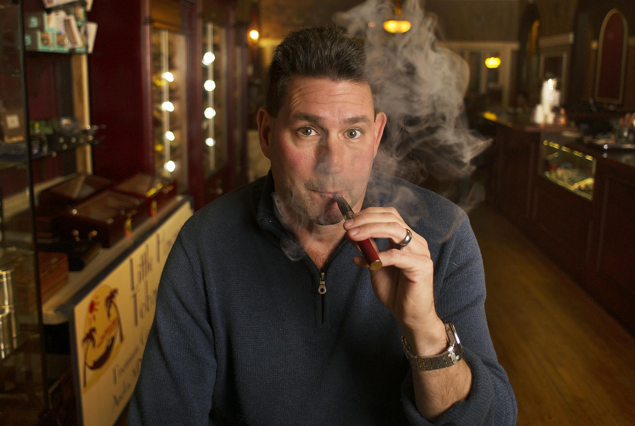 Steve Johnson, owner of Little Havana Tobacco in Anoka, MN, works up a vapor cloud as he uses an electronic cigarette, Thursday, November 7th, 2013. ] (Matthew Hintz, Anoka, 110713)