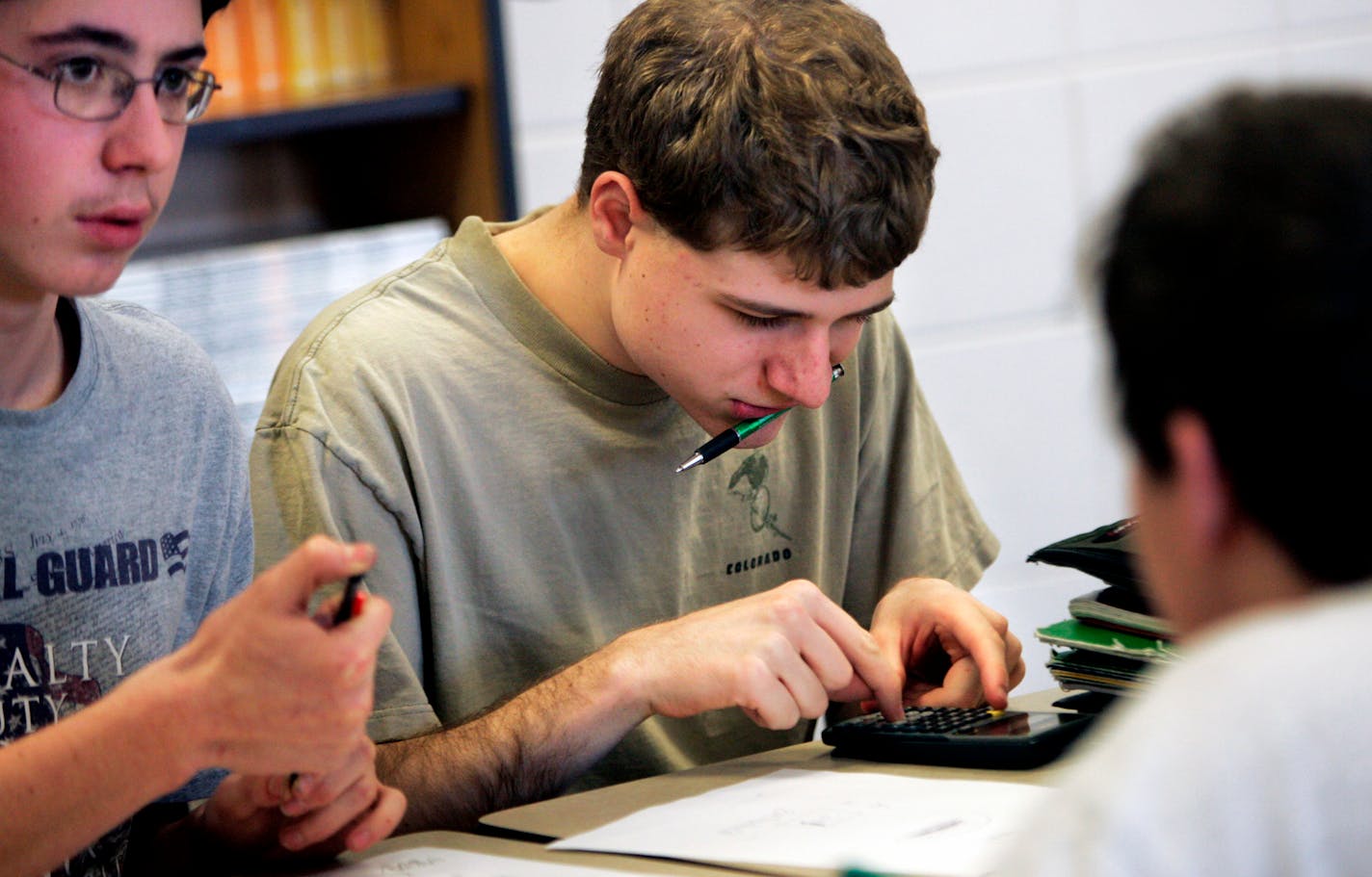 Stefan Kavan, center, used a calculator as he and his teammates practiced Knowledge Bowl questions at New Prague High School in early February.