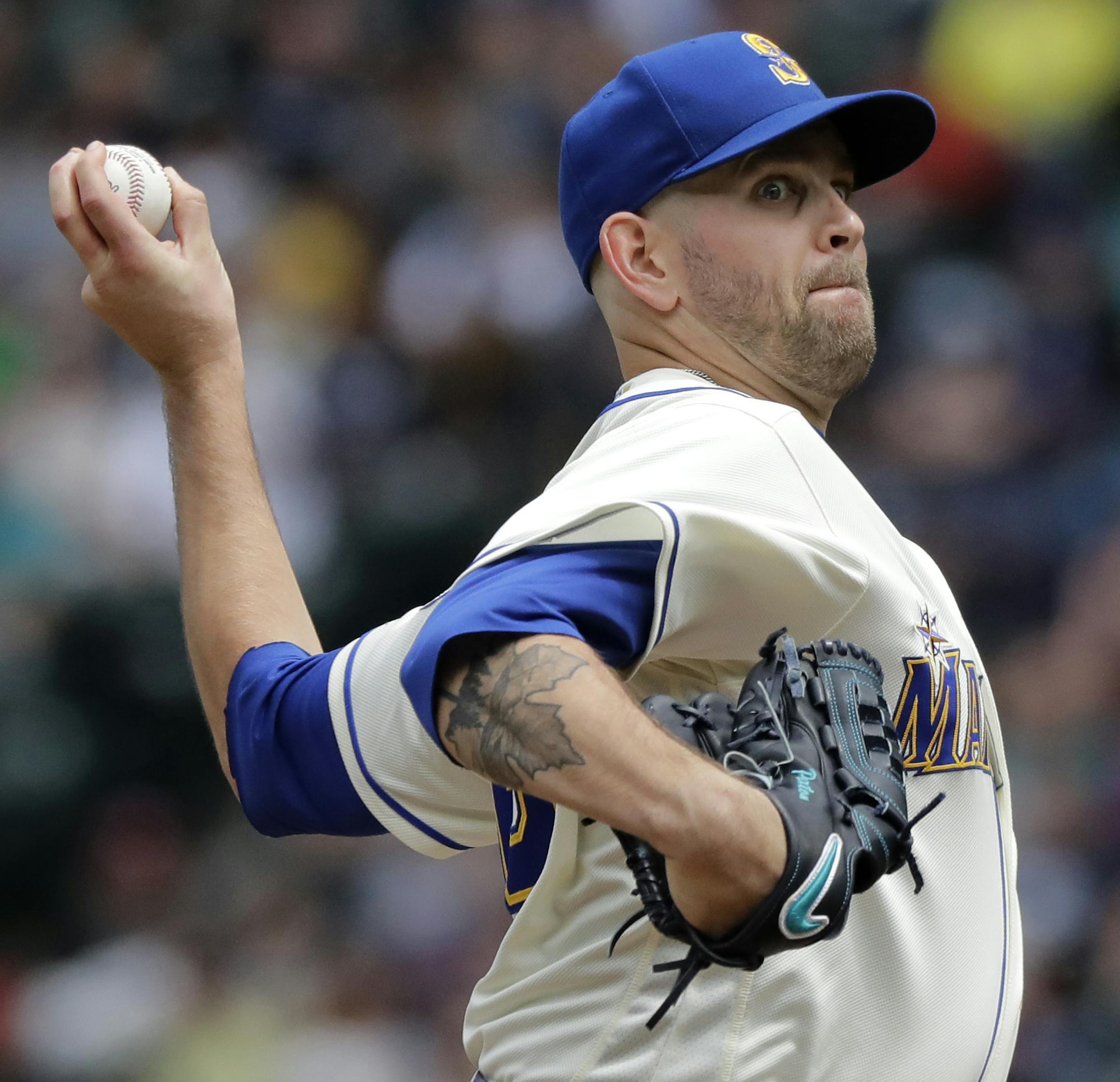 Seattle Mariners starting pitcher James Paxton throws against the Kansas City Royals during the first inning of a baseball game, Sunday, July 1, 2018, in Seattle. Paxton, who is from Canada, and was showing his maple-leaf tattoo, was throwing on the the day of the Mariners' "Canada Day" promotional ball game. (AP Photo/Ted S. Warren)