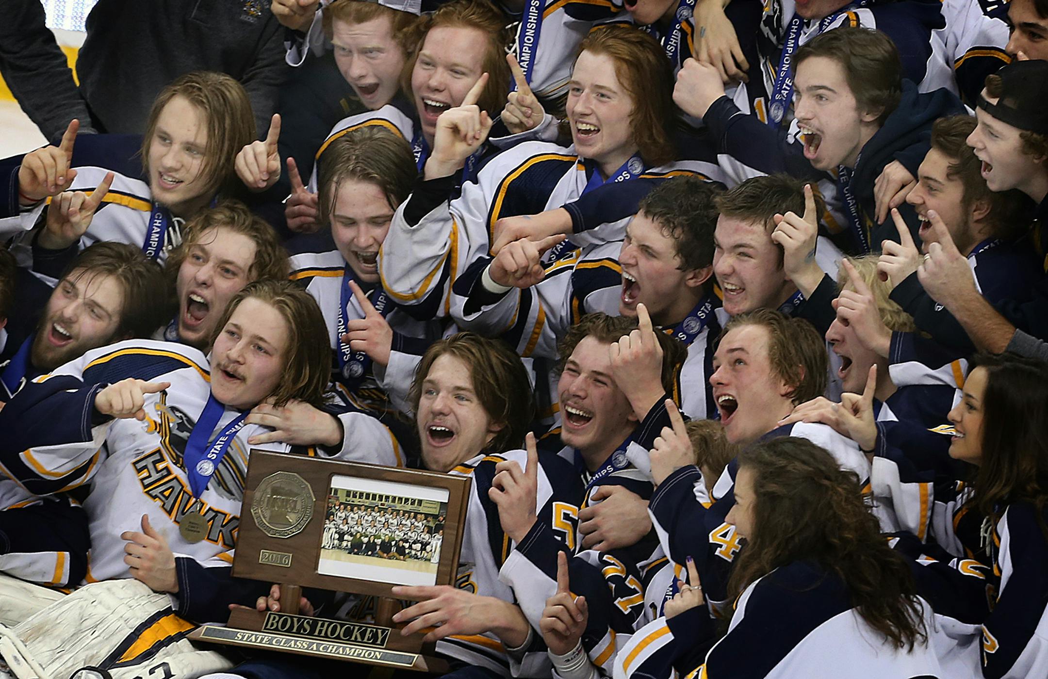 Hermantown players posed for photographs with their championship trophy in the Class 1A boys' hockey state tournament last March. State tournament games for hockey, basketball and football will continue to be shown on 45TV through the 2030-31 school year after the Minnesota State High School League approved an $8.8 million extension of its deal with Hubbard Broadcasting.