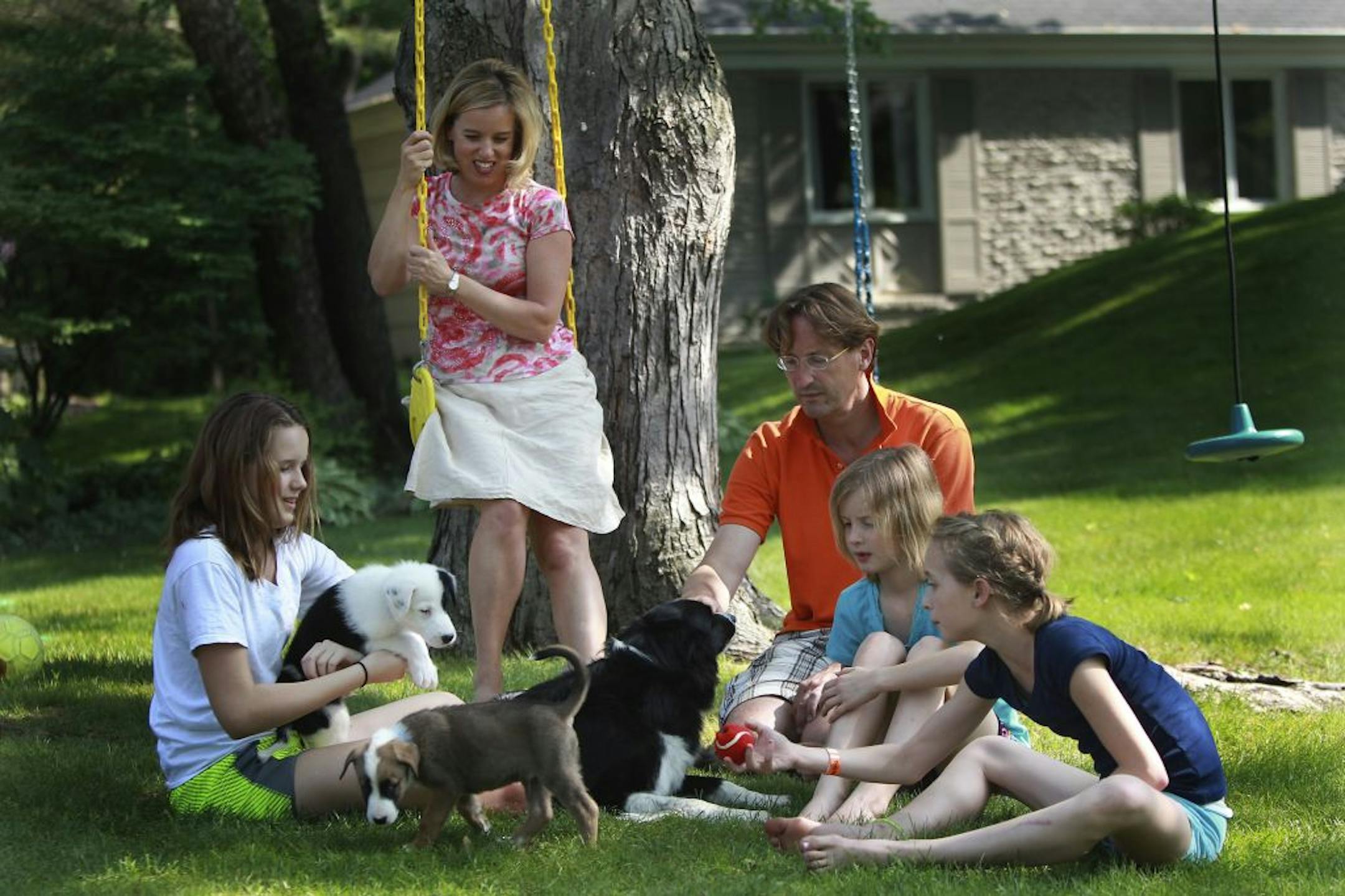 Kelli von Heydekampf and her husband, Mathias, enjoyed shade under a tree at their Edina home with daughters, from left: Olivia, 12, Valentina, 9, and Elizabeth, 11. Kelli keeps the girls busy with educational projects during the summer, but also allows plenty of unscheduled time for fun.