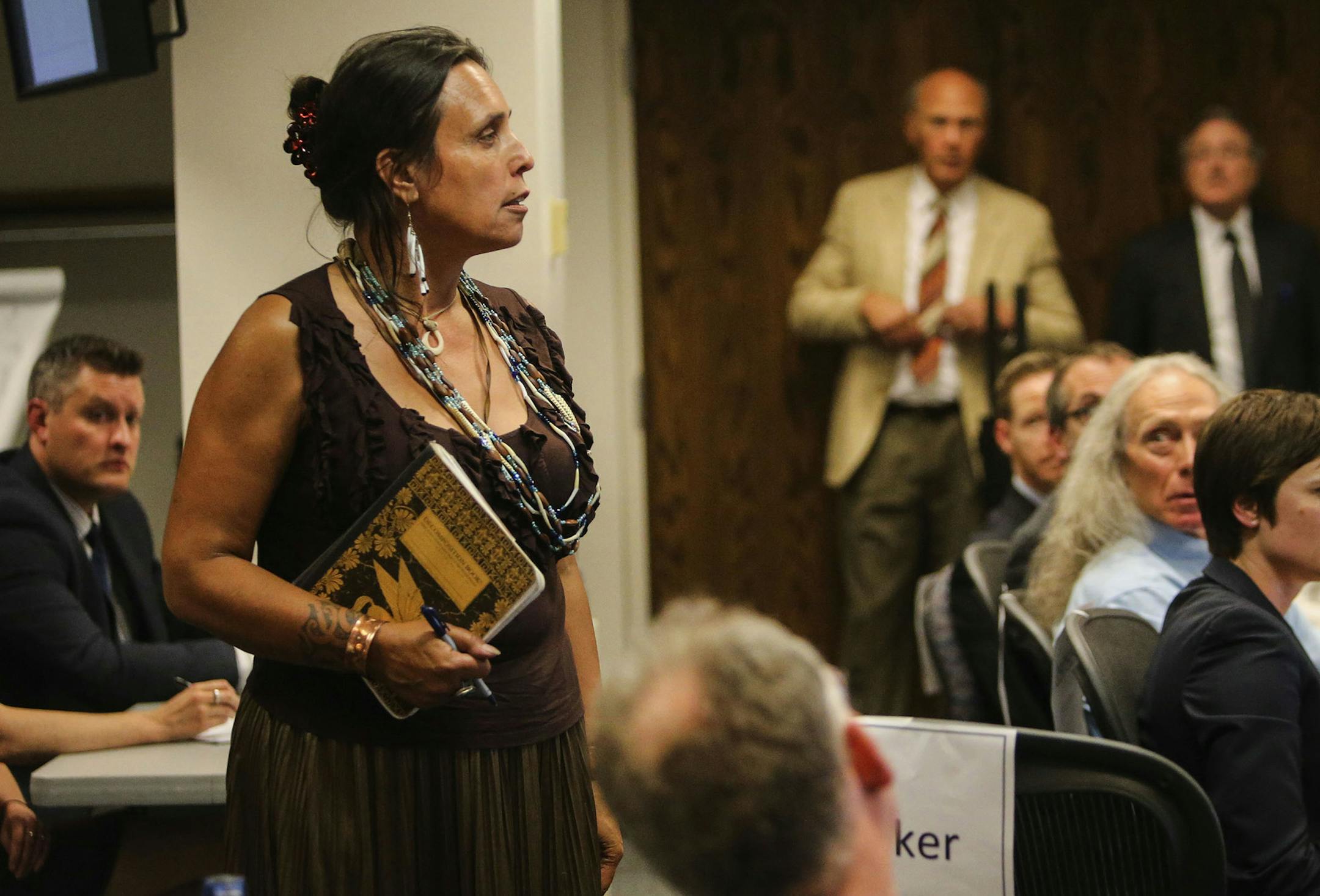 The Minnesota Public Utilities Commission met to consider alternative routes on the proposed Sandpiper pipeline across northern Minnesota to carry Bakken oilThursday, Aug. 7, 2014, in St. Paul. Here, Winona LaDuke, center, an Anishinaabe environmentalist and activist, gets up to introduce herself and let commissioners know she will be speaking later on.] (DAVID JOLES/STARTRIBUNE) djoles@startribune The Minnesota Public Utilities Commission met to consider alternative routes to for the Sandpiper