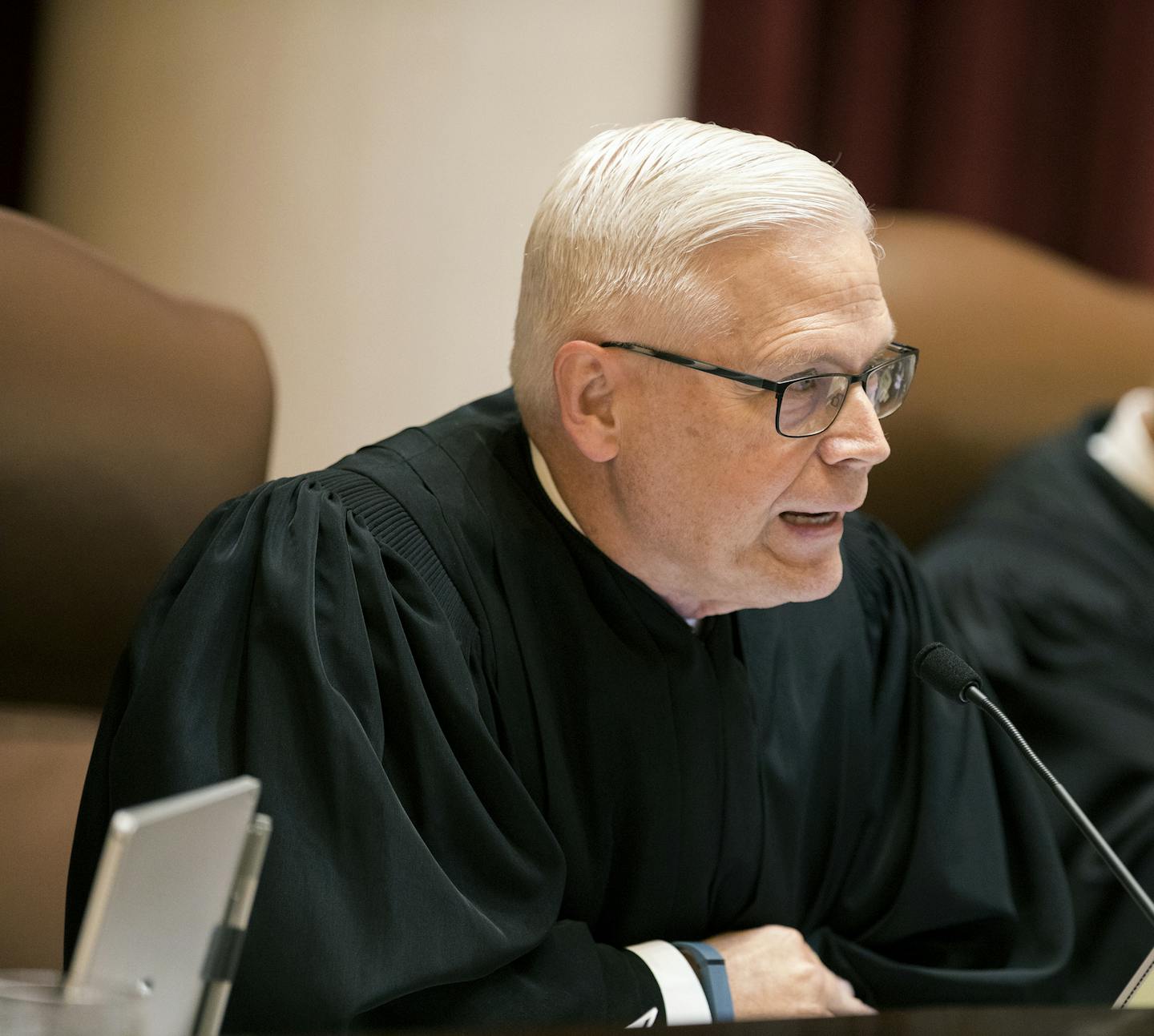 FILE - In this Aug. 28, 2017 file photo, Minnesota Supreme Court Associate Justice David L. Lillehaug asks questions during oral arguments at the Capitol in St. Paul, Minn. Lillehaug says he has Parkinson's disease and won't seek re-election next year. Lillehaug says in a statement via the court that he expects to resign in July 2020. (Leila Navidi/Star Tribune via AP, File)