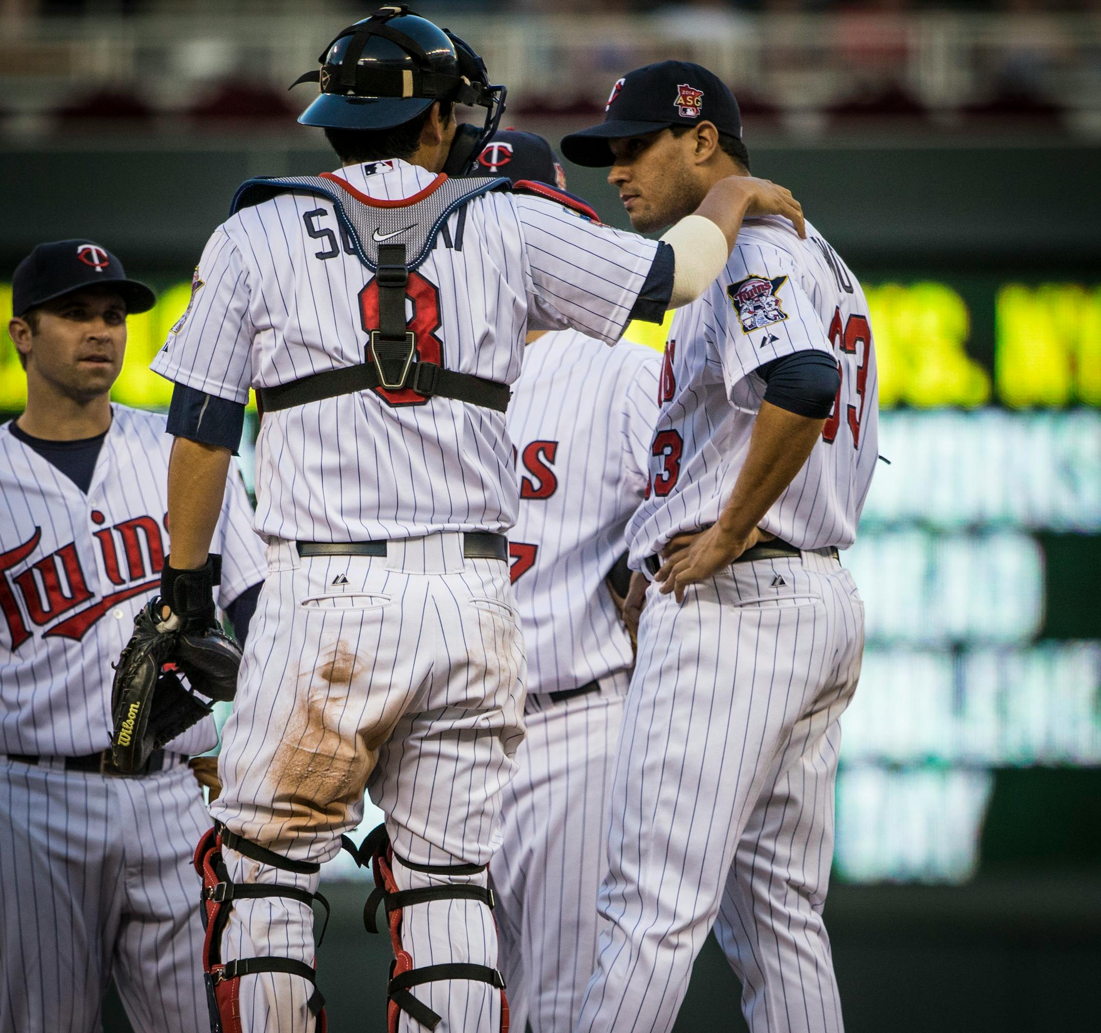 Twins catcher Kurt Suzuki spoke to pitcher Yohan Pino as they met on the mound in during the fourth inning on Monday. Pino took the loss as the Twins fell 6-1 to Kansas City.