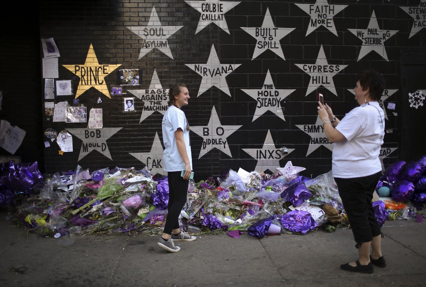 Fans took their picture in front of Prince's now-gold star on the wall of First Ave. earlier this week.