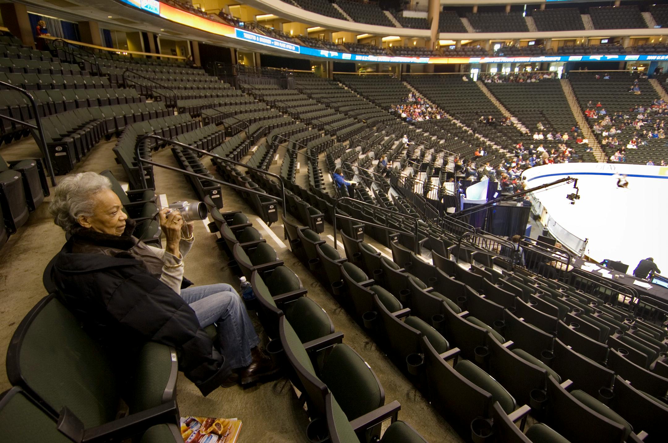 Dell Pellegrini, a longtime figure skating fan from New York City, watched and took pictures from high in the stands Thursday morning during skaters' practice at the U.S. Figure Skating Championships. It was her 74th birthday. Organizers are expecting 125,000 to attend the eight-day event.
