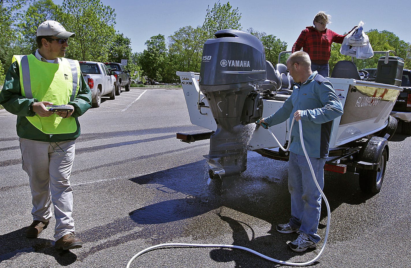 In 1995, the DNR started a system of intermittent, at-the-ramp boat inspections like this one on Lake Minnetonka to thwart aquatic invasive species (AIS). This year, a local pilot project in Wright County is attempting to prove that mandatory, centralized AIS inspections can be affordable and more comprehensive. (ELIZABETH FLORES/STAR TRIBUNE) ELIZABETH FLORES &#x2022; eflores@startribune.com