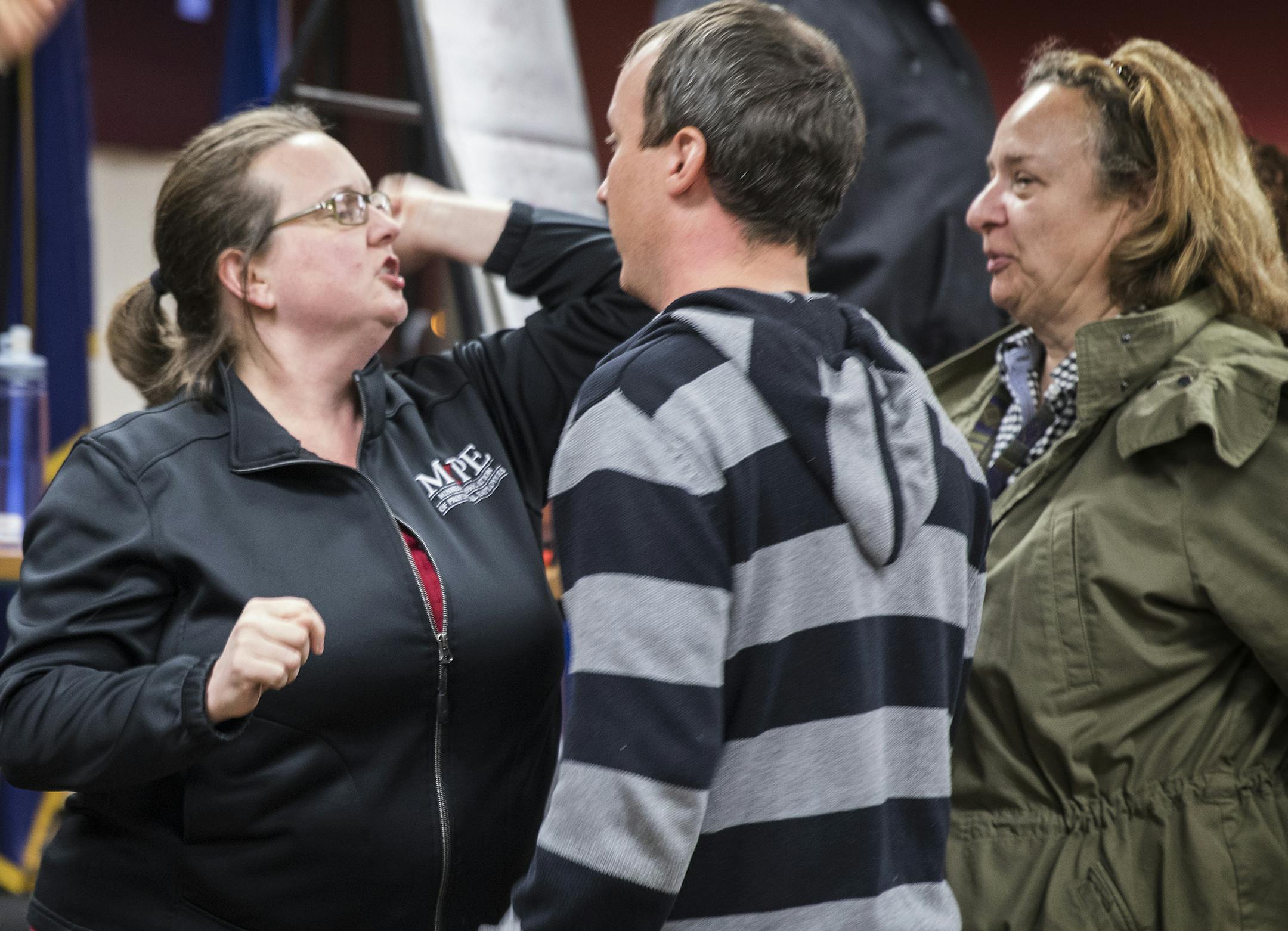 Trainer Debra Prokopf of Minnesota Association of Professional Employees, center in black, plays out a potential scenario as a counter protester during marshall training with Gena Berglund, left, co-captain of the marshalls and fellow trainer Steve Payne, in striped top, of the SEIU, as volunteer marshalls watch the scene to learn how to deal with potentially violent counter protesters. ] (Leila Navidi/Star Tribune) leila.navidi@startribune.com BACKGROUND INFORMATION: Marshall training for volun
