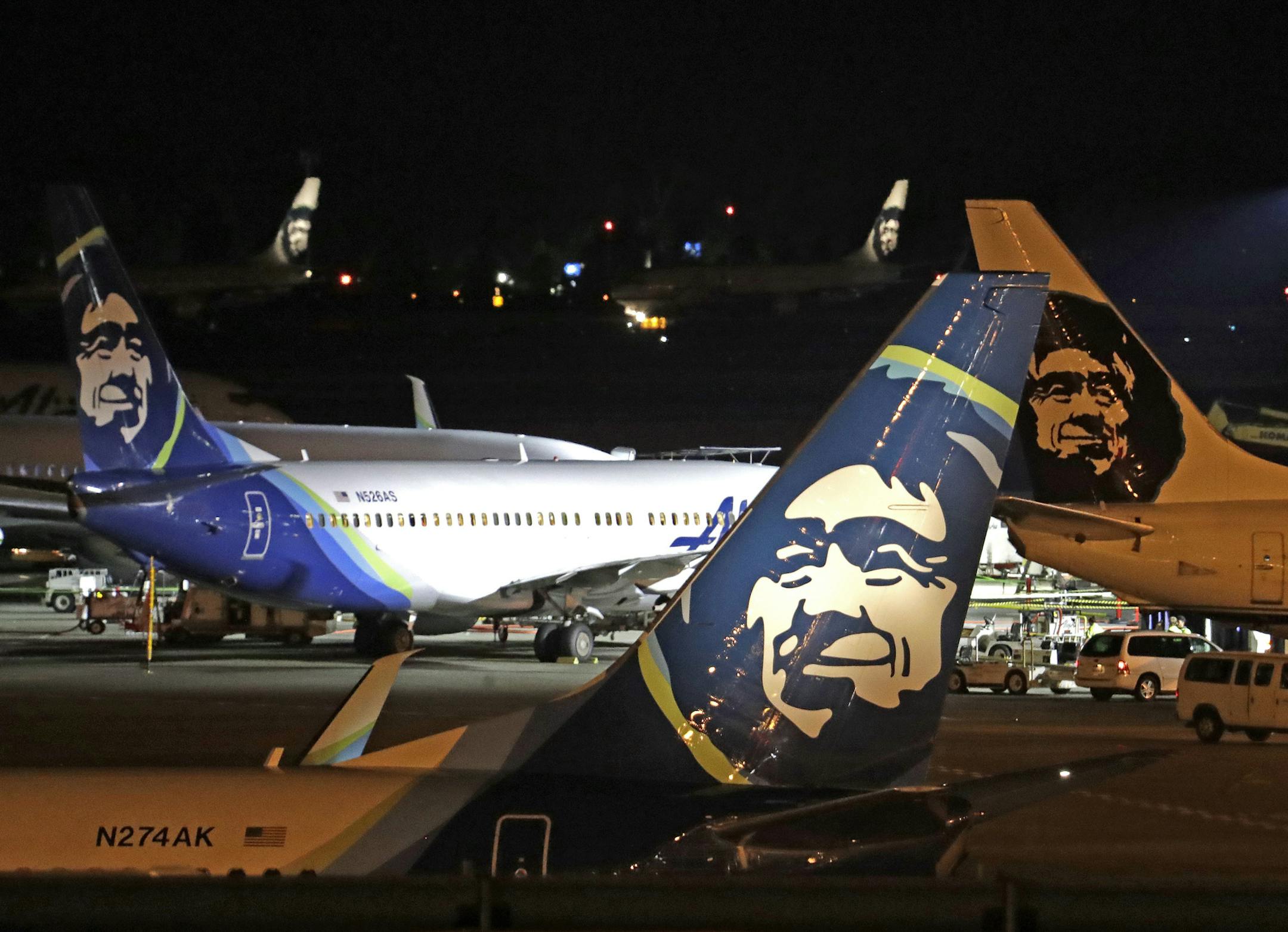 FILE - In this Friday, Aug. 10, 2018 file photo, Alaska Airlines planes sit on the tarmac at Sea-Tac International Airport in SeaTac, Wash., hours after airport worker Richard Russell stole a 76-seat turboprop plane owned by Alaska Airlines subsidiary Horizon Air, and performed acrobatic stunts before taking a fatal plunge into Ketron Island. (AP Photo/Elaine Thompson, File) ORG XMIT: FX104
