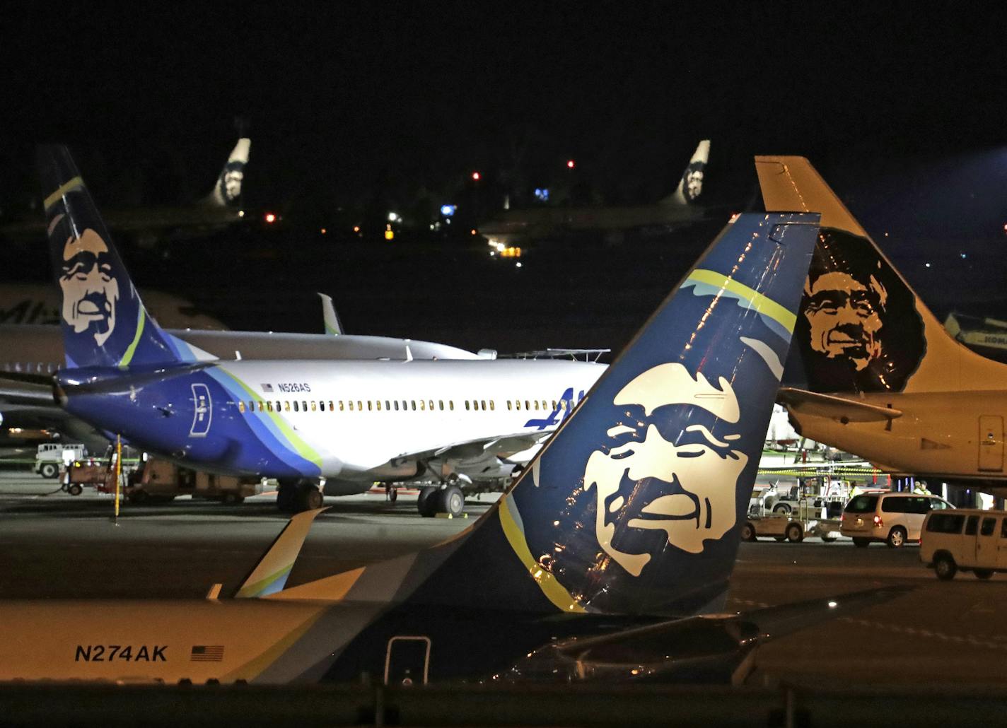 FILE - In this Friday, Aug. 10, 2018 file photo, Alaska Airlines planes sit on the tarmac at Sea-Tac International Airport in SeaTac, Wash., hours after airport worker Richard Russell stole a 76-seat turboprop plane owned by Alaska Airlines subsidiary Horizon Air, and performed acrobatic stunts before taking a fatal plunge into Ketron Island. (AP Photo/Elaine Thompson, File) ORG XMIT: FX104