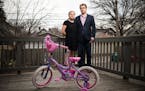Hannah and David Edwards were photographed behind their home with their 5-year-old daughter's bicycle on Tuesday, April 12, 2016 in St. Paul, Minn.