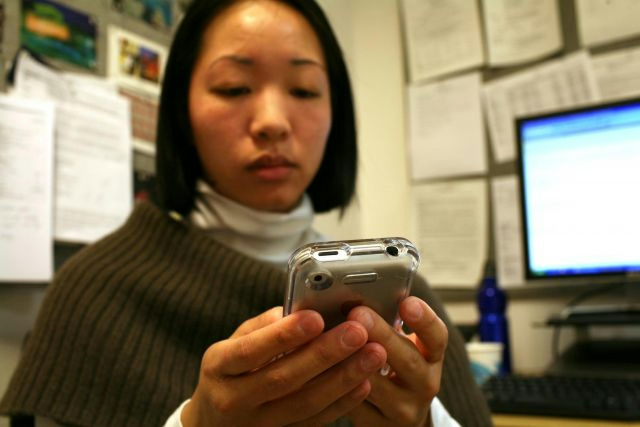 Yen Cheong types out a text message on her cell phone in New York on March 31, 2009. "Once upon a time, voice mail was useful," she says.