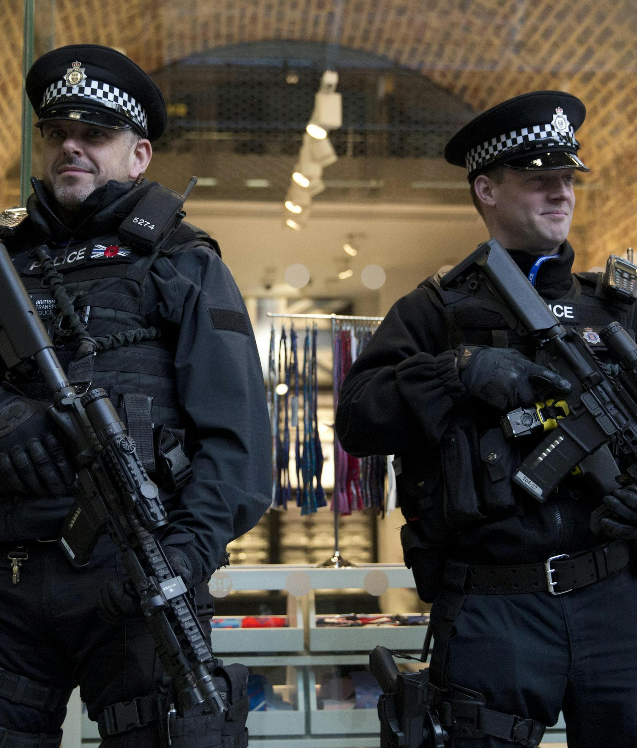 Armed British police officers stand guard after Eurostar services were suspended on the Brussels route because of the attacks in Belgium, at St Pancras international railway station in London, Tuesday, March 22, 2016. Authorities in Europe and beyond have tightened security at airports, on subways, at the borders and on city streets after deadly attacks Tuesday on the Brussels airport and its subway system. (AP Photo/Matt Dunham)