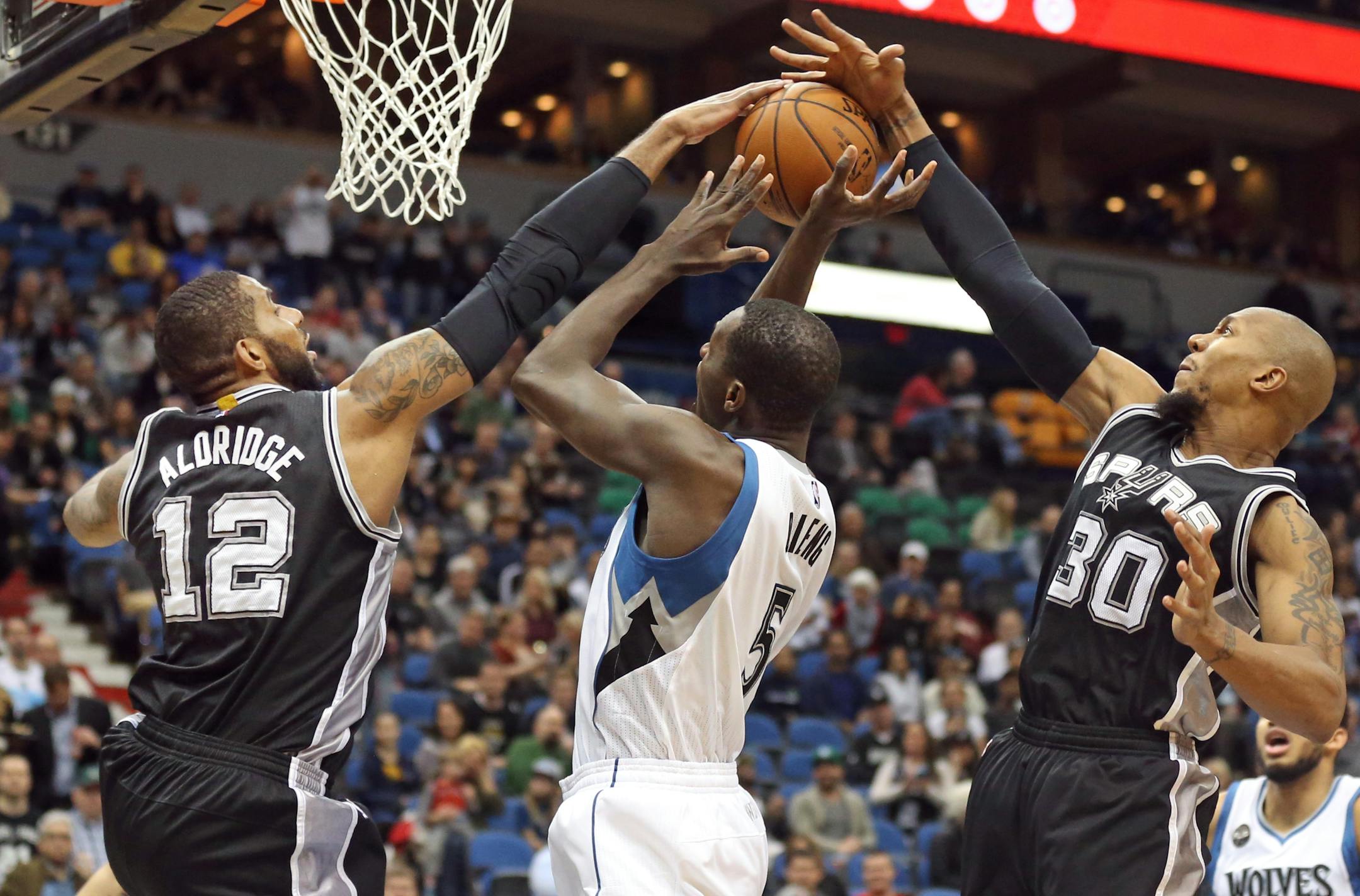 LaMarcus Aldridge, left, and forward David West blocked a shot attempt of Timberwolves center Gorgui Dieng.