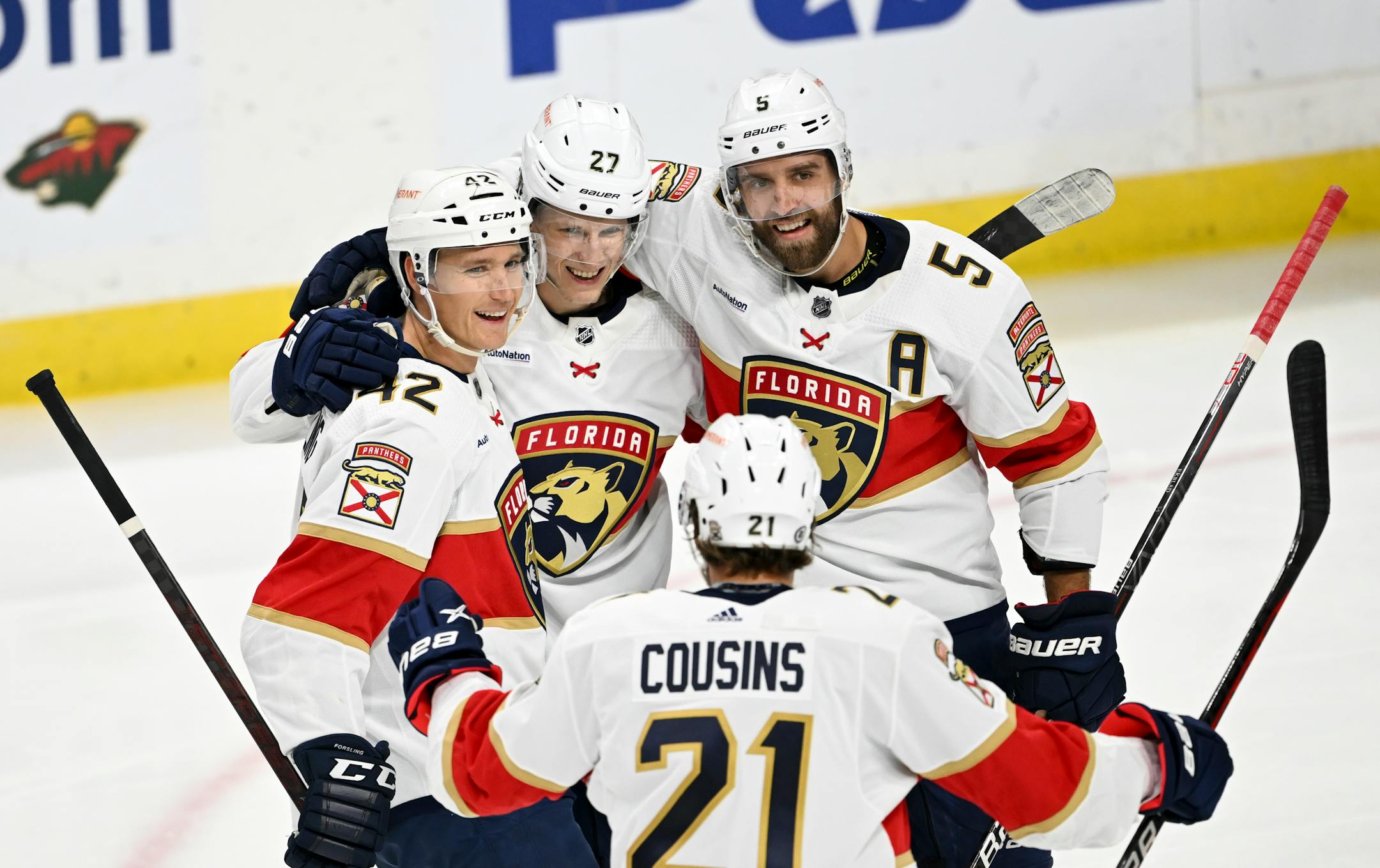 Florida Panthers defenseman Gustav Forsling (42), center Eetu Luostarinen (27), defenseman Aaron Ekblad (5) and center Nick Cousins (21) celebrate a goal by Luostarinen against the Minnesota Wild during the second period.