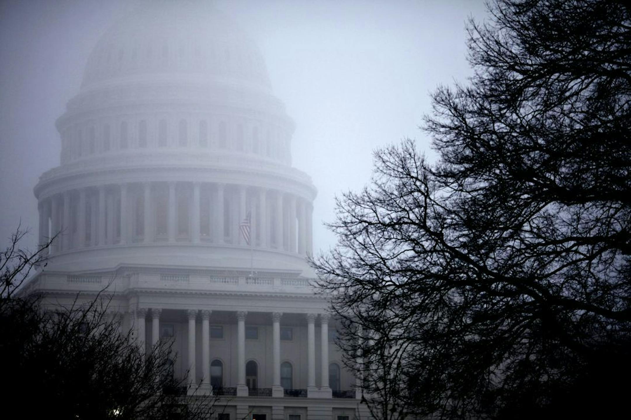 Fog obscures the Capitol dome on Capitol Hill in Washington.