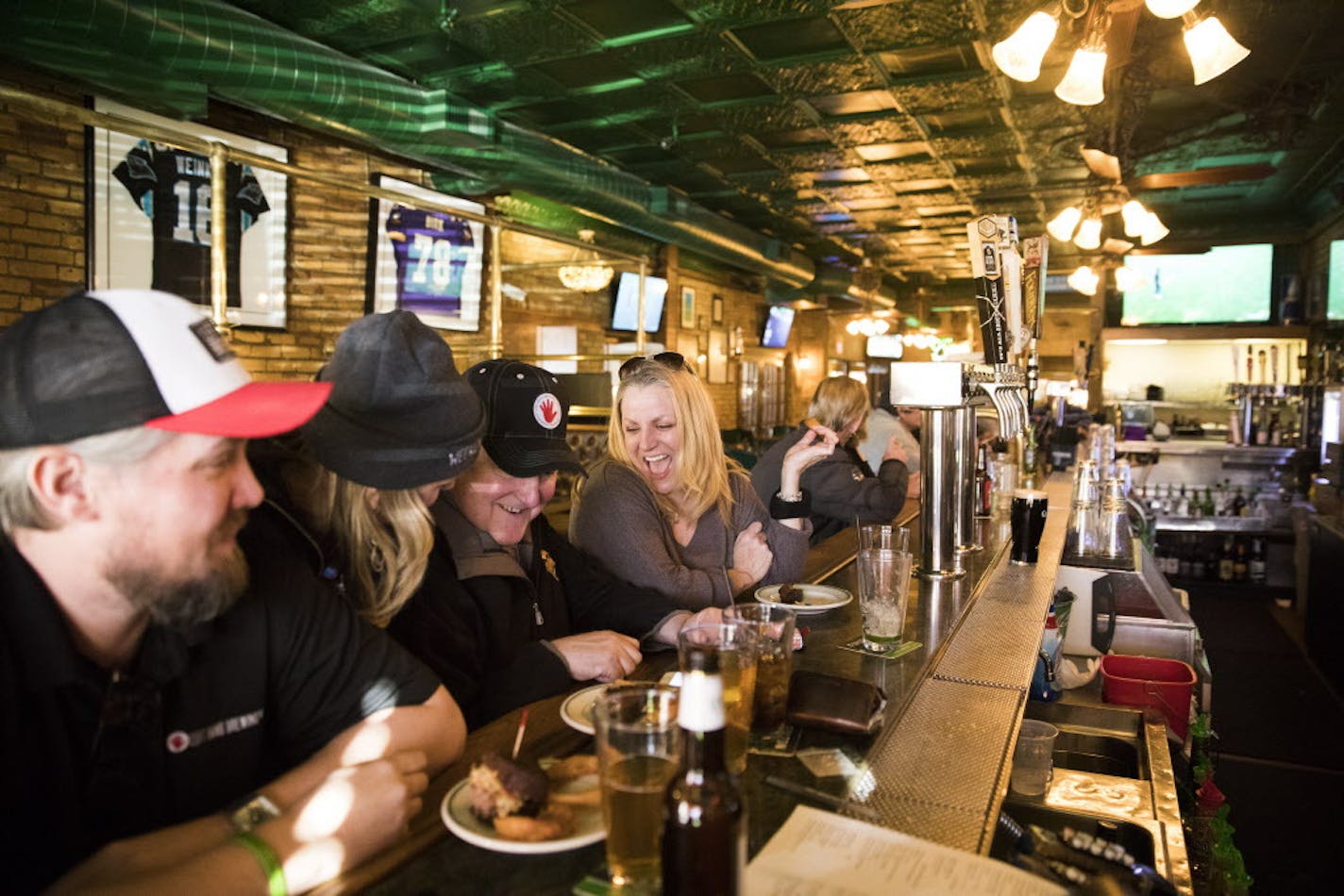 O'Gara's regulars Joe Shea, from left, Patrick Lynch and Sara Clemetson chat at the bar. Shea has been coming to O'Gara's with his family since he was a child. Lynch, also known as "Chopper" worked at O'Gara's for 12 years about 20 years ago. ] LEILA NAVIDI &#xef; leila.navidi@startribune.com BACKGROUND INFORMATION: (**NOTE THE WOMAN WITH THE GRAY HAT SECOND FROM LEFT DIDN'T WANT HER NAME IN THE PAPER) Happy hour at O'Gara's in St. Paul on Thursday, March 1, 2018. O'Gara's, at the same corner in