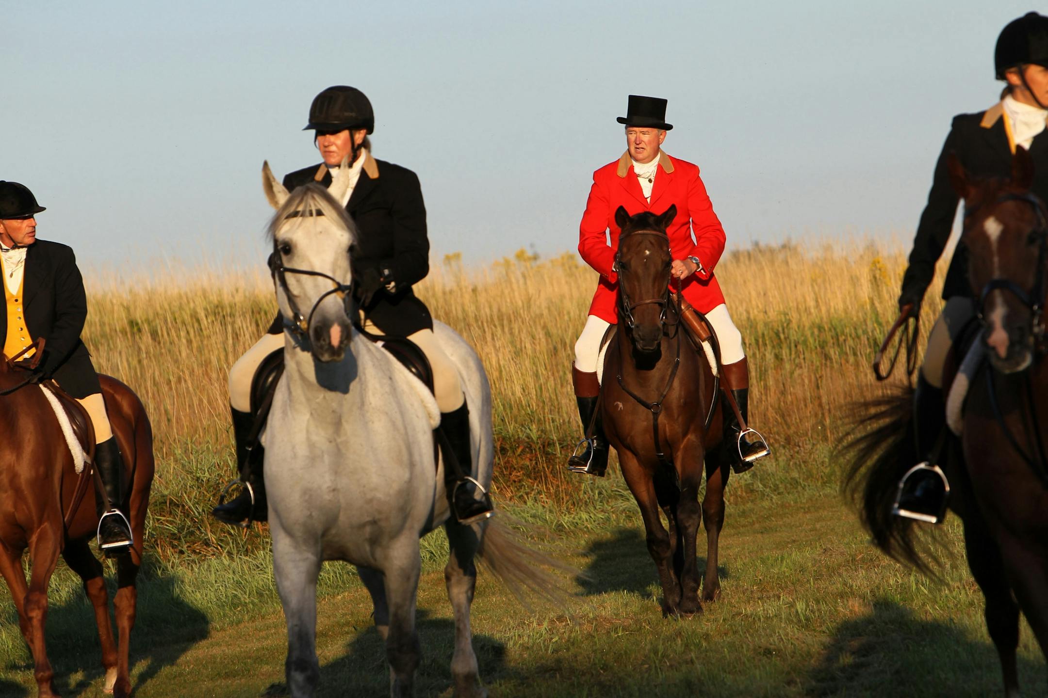 David Stene, second from right, of Dayton rode into a clearing at the close of the Long Lake Hounds hunt in Medina on Sept. 10.