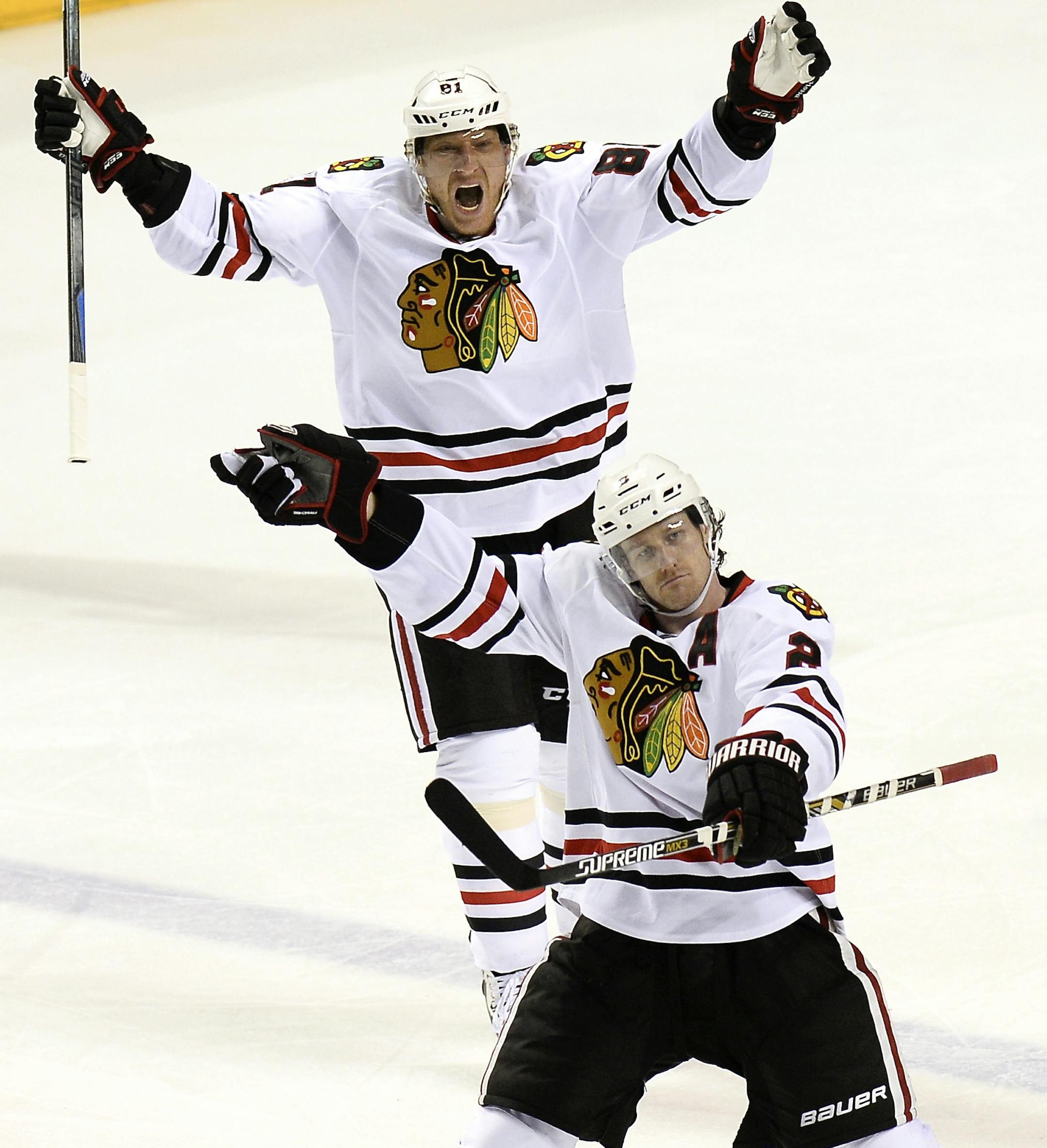 Chicago Blackhawks defenseman Duncan Keith, bottom, and Marian Hossa (81), of Slovakia, celebrate after Keith scored the game-winning goal against the Nashville Predators in the second overtime of Game 1 of an NHL Western Conference hockey playoff series Wednesday, April 15, 2015, in Nashville, Tenn. The Blackhawks won 4-3. (AP Photo/Mark Zaleski)
