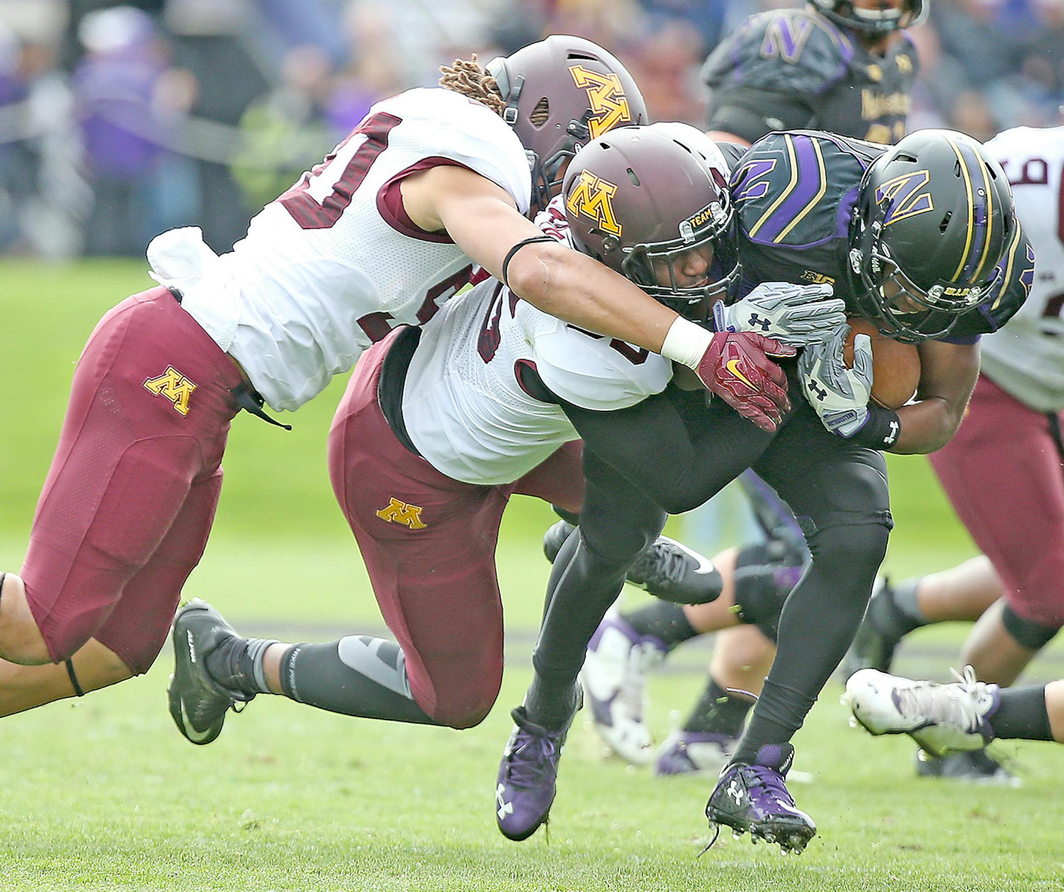 Northwestern's running back Justin Jackson plowed his way passed Minnesota's linebacker Jack Lynn, left, and Theiren Cockran in the second quarter as Minnesota took on the Northwestern Wildcats at Ryan Field, Saturday, October 3, 2015 in Evanston, IL. ] (ELIZABETH FLORES/STAR TRIBUNE) ELIZABETH FLORES • eflores@startribune.com