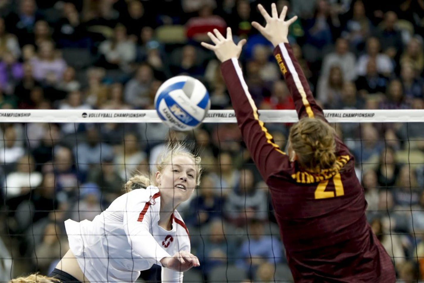 Stanford's Kathryn Plummer, left, drives a spike past Minnesota's Regan Pittman (21) for a point during the semifinals of the NCAA Division I women's volleyball championships Thursday, Dec. 19, 2019, in Pittsburgh.