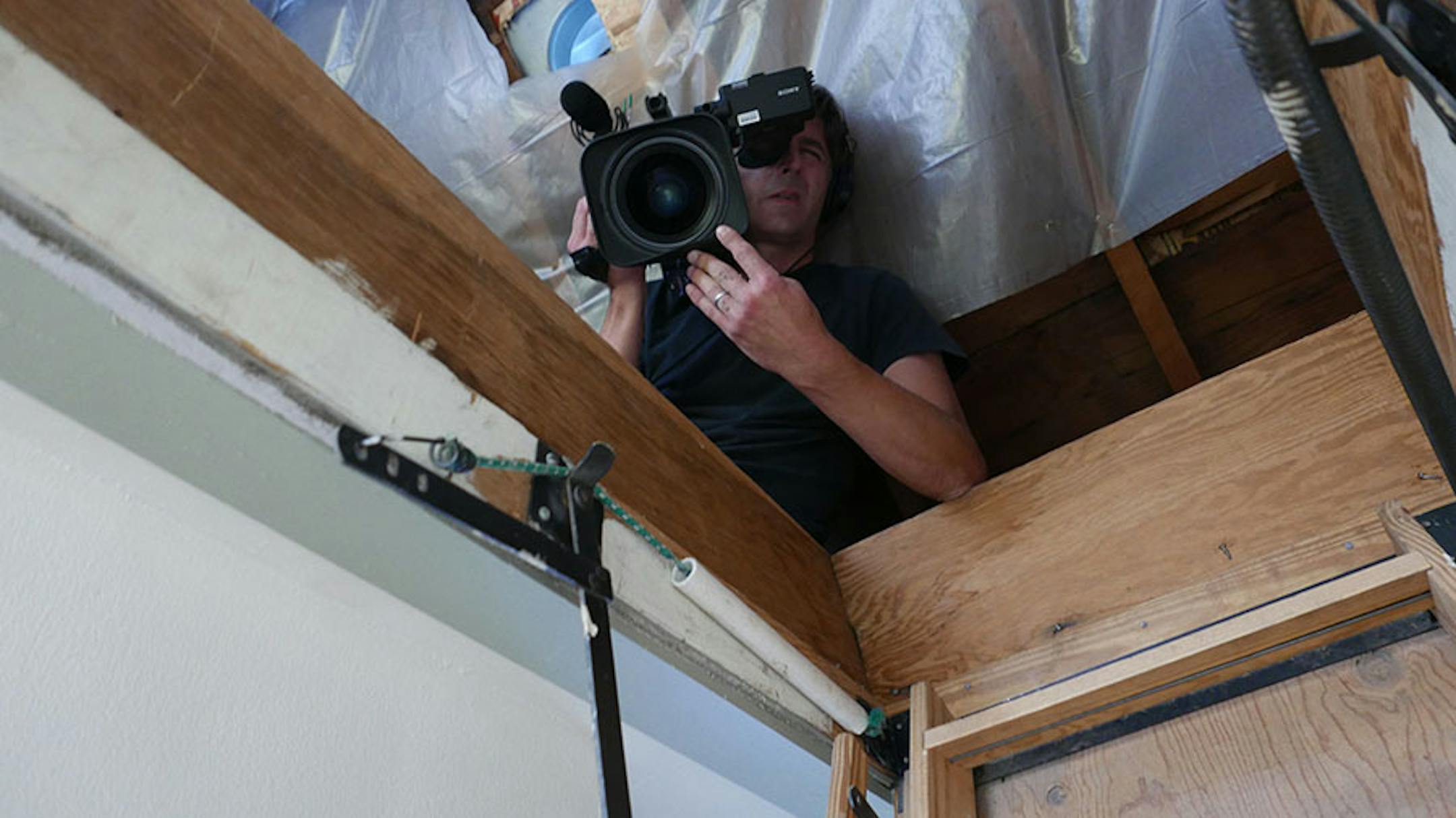 Camerman Jay Maurer shoots Kim Bokovoy and contractor Tom Silva replaced the attic staircase in her Mpls. home in an episode of "Ask This Old House," Provided