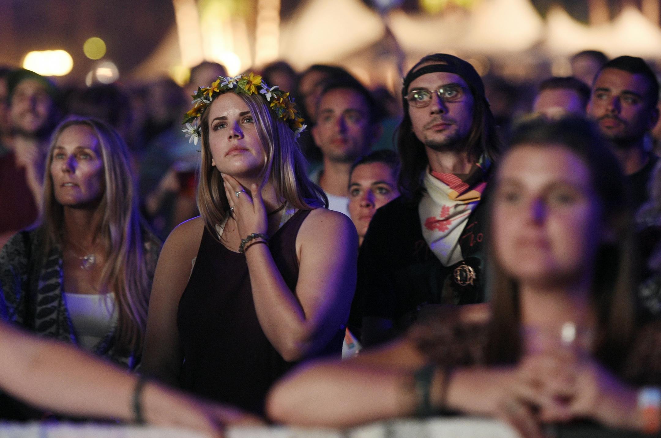 Festival goers watch Neil Young's performance on day 2 of the 2016 Desert Trip music festival at Empire Polo Field on Saturday, Oct. 8, 2016, in Indio, Calif.