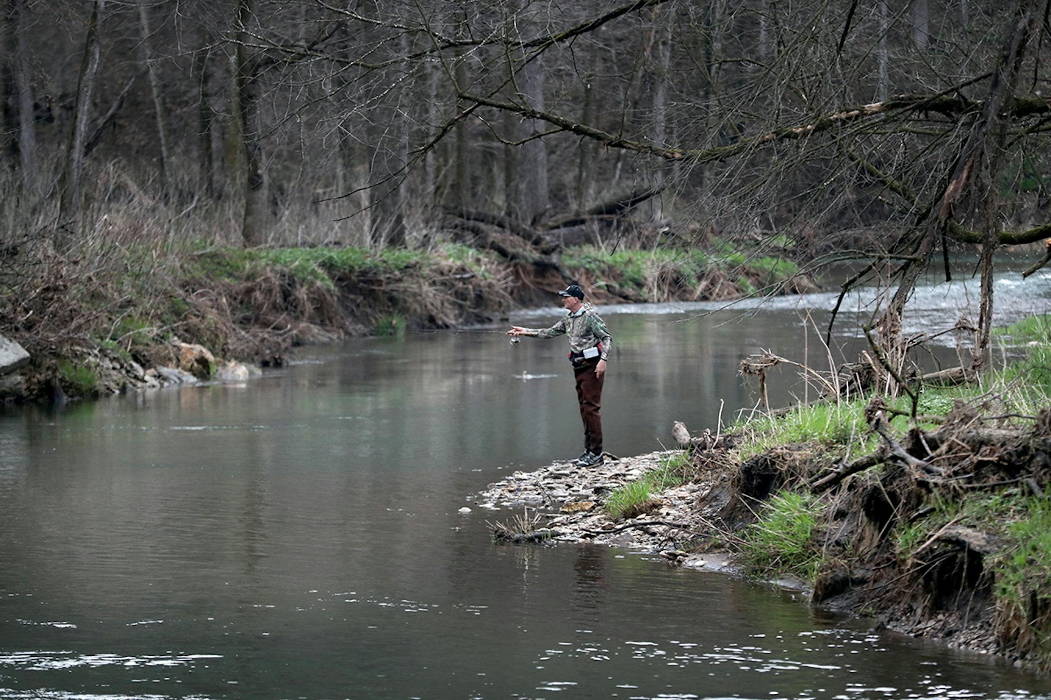 A spin fisher casts his line in the waters of the South Branch of the Root River in Forestville/Mystery State Park Saturday, April 15, 2017, in Preston, MN.] DAVID JOLES • david.joles@startribune.com Trout fishing opener on the South Branch of the Root River Saturday, April 15, 2017, in Preston, MN.
