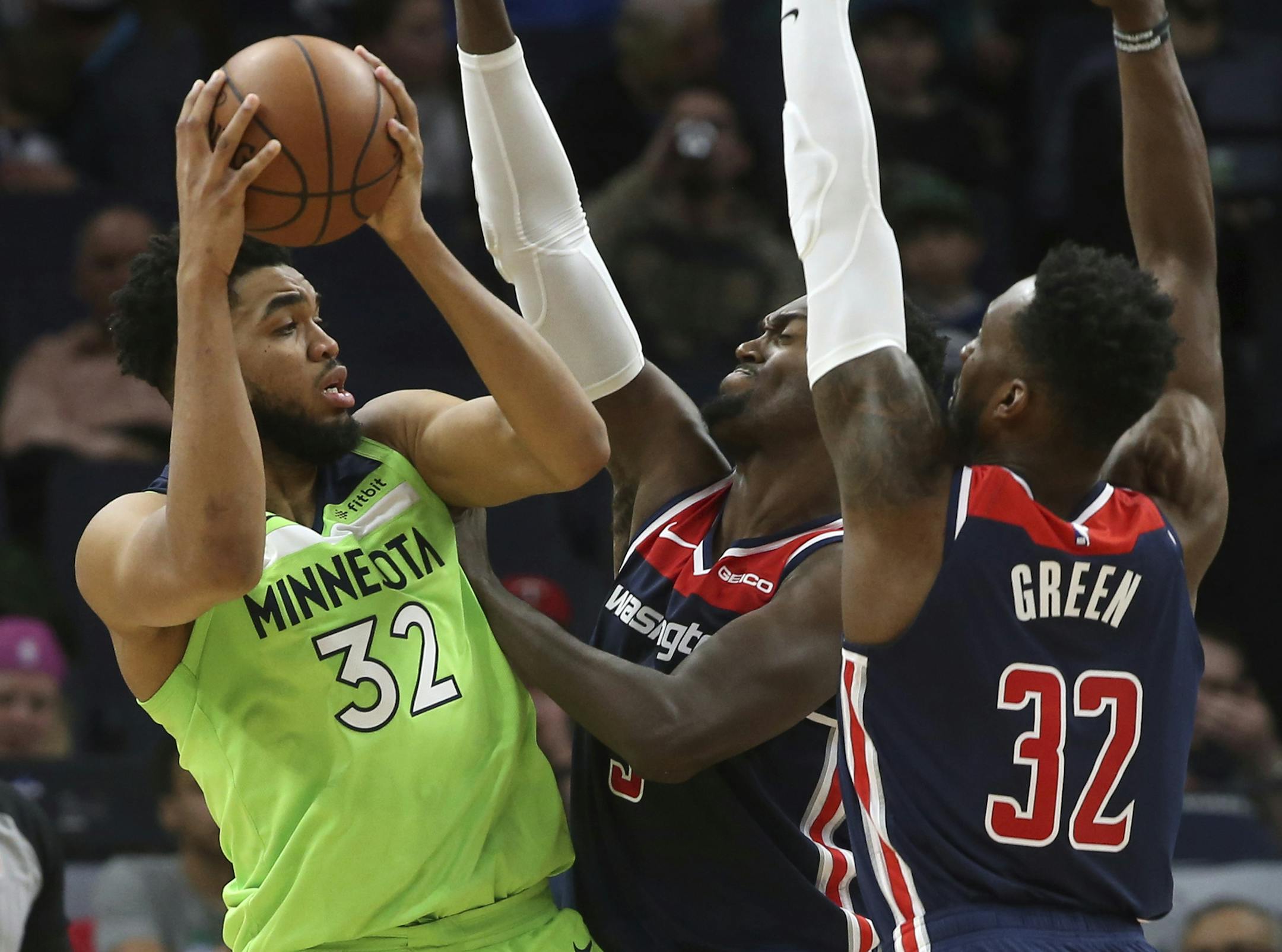 Minnesota Timberwolves' Karl-Anthony Towns, left, is double-teamed by Washington Wizards' Bobby Portis, center, and Jeff Green in the second half of an NBA basketball game Saturday, March 9, 2019, in Minneapolis. (AP Photo/Jim Mone)