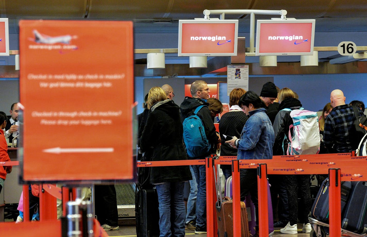 Passengers wait in line at the counters of budget carrier Norwegian at Stockholm Arlanda Airport March 5, 2015. 650 pilots employed by Norwegian Air Norway (NAN) are on strike grounding flights in Norway, Sweden and Denmark. (AP Photo/Johan Nilsson / TT) SWEDEN OUT ORG XMIT: STO808