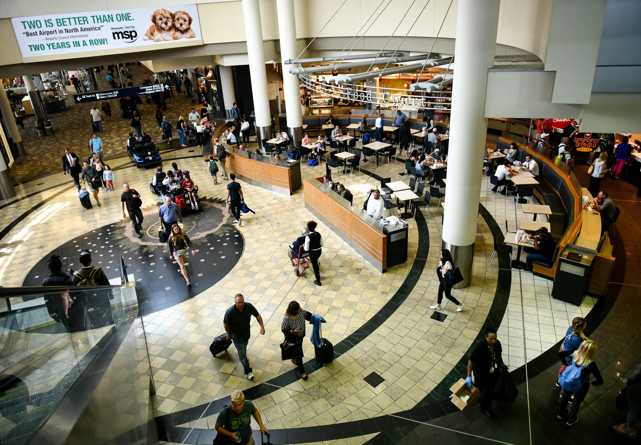 Travelers and airport employees made their way past the Concourse C food court Wednesday. ] AARON LAVINSKY • aaron.lavinsky@startribune.com Four new food courts are being built at the Minneapolis-St. Paul International Airport, including one along the main mall. The idea is to provide fresh, affordable offerings for passengers and employees alike. We photograph some of the food courts, both currently in use and under construction, on Wednesday, July 11, 2018 at MSP's terminal one.