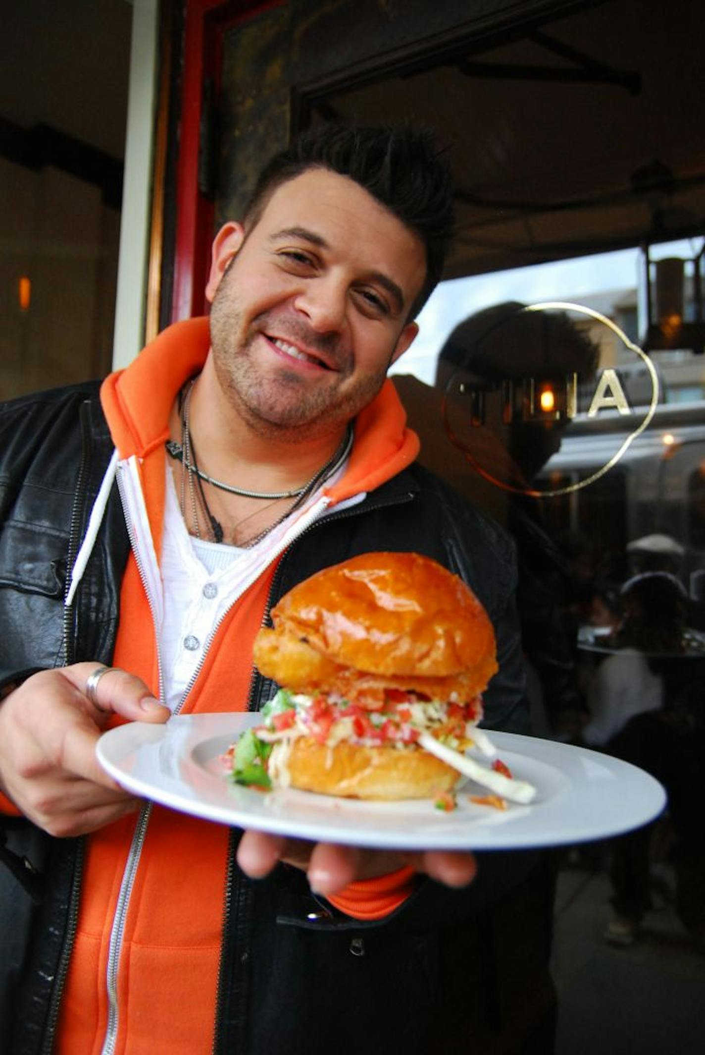 The host of "Adam Richman's Best Sandwich in America" at a stop in Minneapolis for Tilia's fish taco torta.