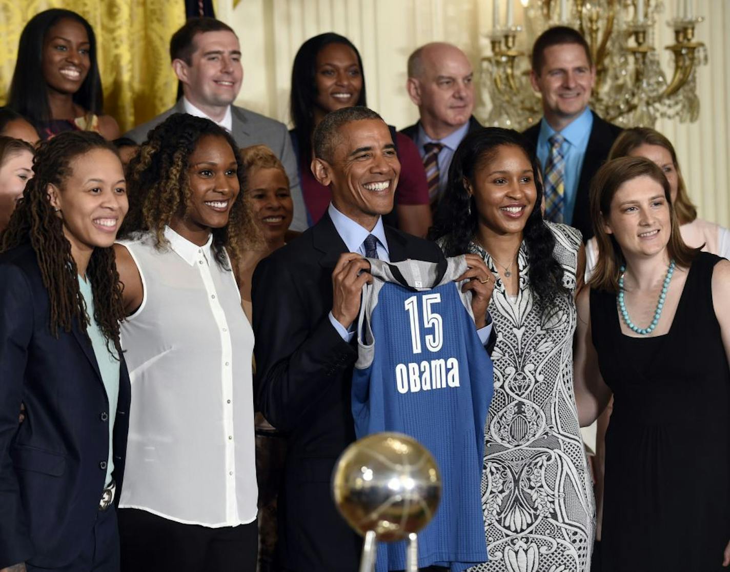 President Barack Obama holds up a jersey as he poses for a photo in the East Room of the White House in Washington, Monday, June 27, 2016, during a ceremony where he honored the 2015 WNBA basketball Champion Minnesota Lynx. (AP Photo/Susan Walsh) ORG XMIT: MIN2016062717090240