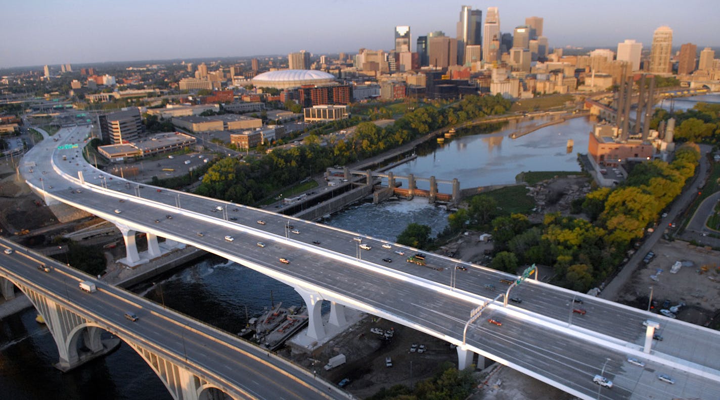 Richard Sennottïrsennott@startribune.com First light paints the 35W bridge on the the opening day with the Minneapolis skyline ORG XMIT: MIN2014072616493176
