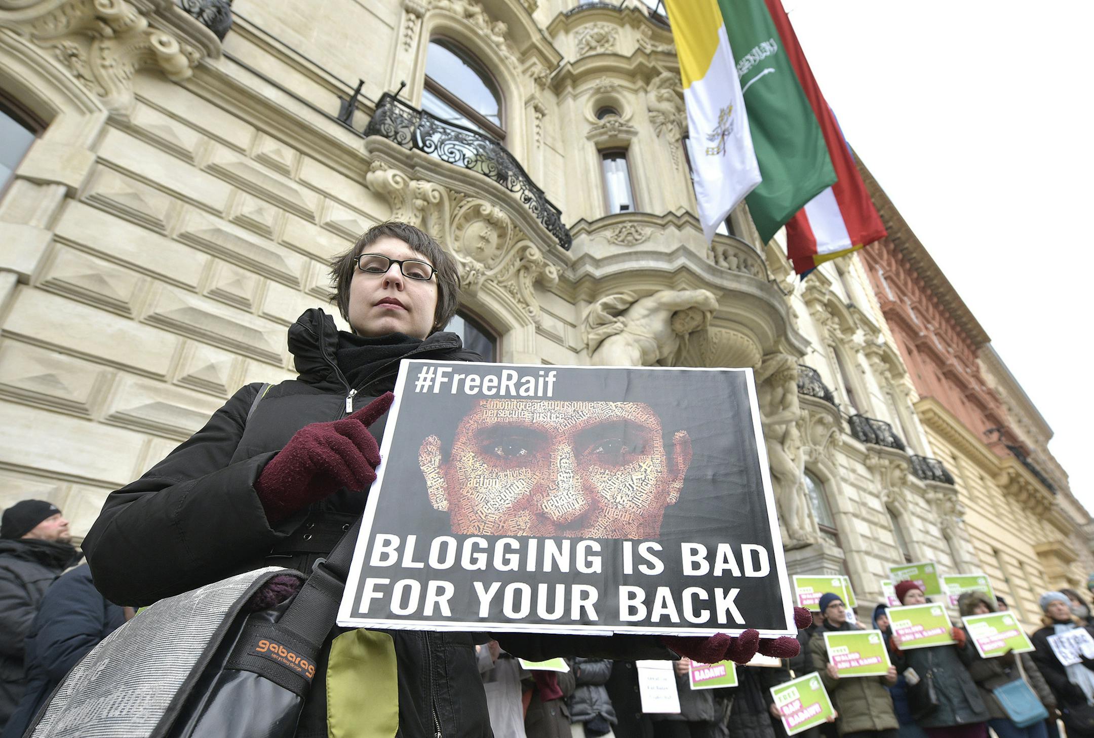 In this picture taken Friday, Feb. 6, 2015, members of the Austrian Greens attend a protest by the Austrian Greens against the punishment for Saudi blogger Raif Badawi in front of the KAICIID in Vienna, Austria. Austria was enthusiastic when Saudi Arabia said it was ready to bankroll a center for religious and cultural understanding in Vienna _ but two years later the desert kingdomís foray into promoting a more open society abroad while continuing to repress rights at home is in tatters. (